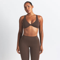NikeSKIMS MATTE TWIST-FRONT BRA | DARK SEPIA ON A MODEL BACK VIEW @ | FOCUS: 0.0, 1.0, 0.9
