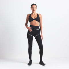 NikeSKIMS MATTE TWIST-FRONT BRA | OBSIDIAN ON A MODEL FRONT VIEW @ | FOCUS: 0.0, 1.0, 0.9