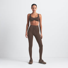 NikeSKIMS MATTE SHAPING SCOOP BRA | DARK SEPIA ON A MODEL FRONT VIEW @ | FOCUS: 0.0, 1.0, 0.9