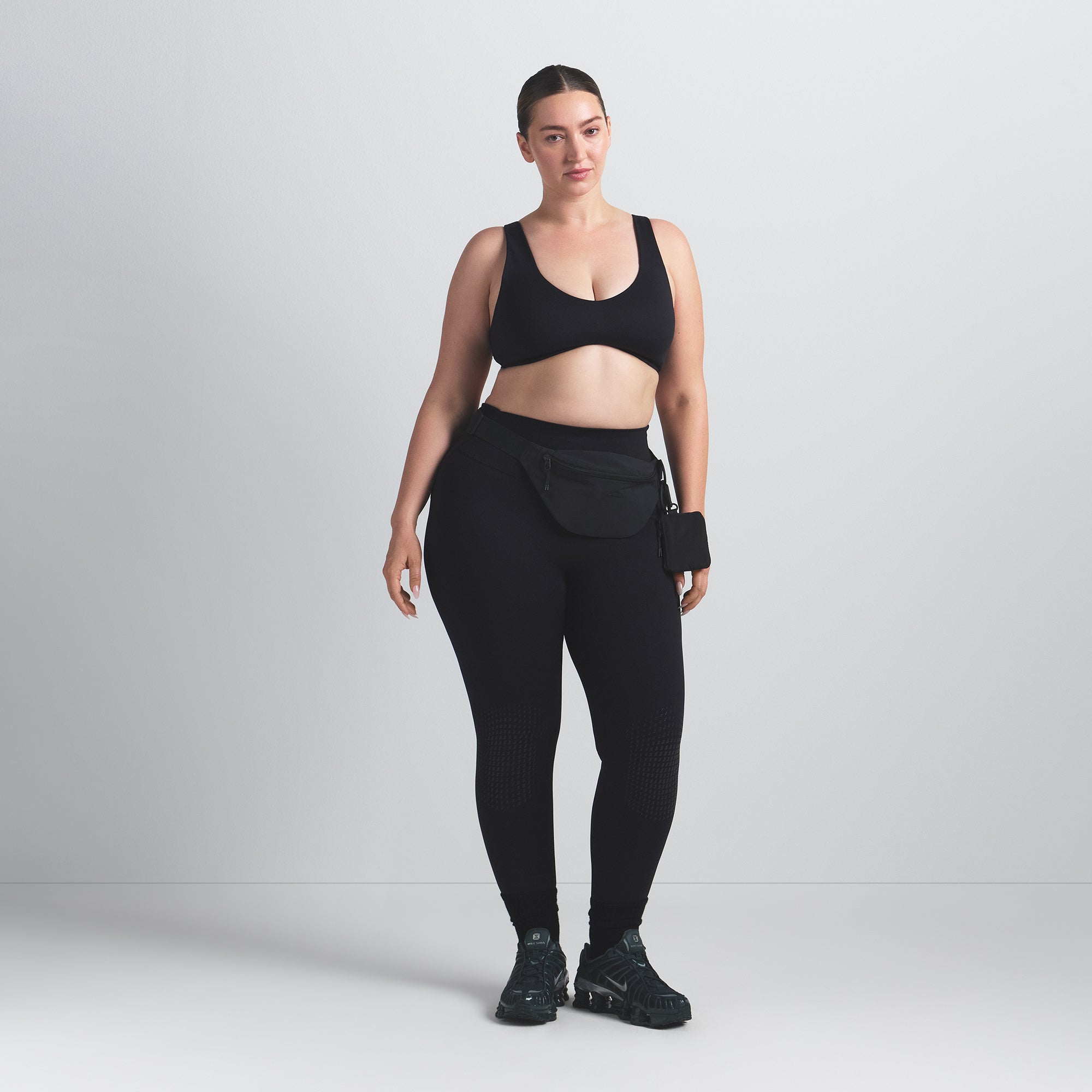 NikeSKIMS MATTE SHAPING SCOOP BRA | OBSIDIAN ON A MODEL FRONT VIEW @ | FOCUS: 0.0, 1.0, 0.9