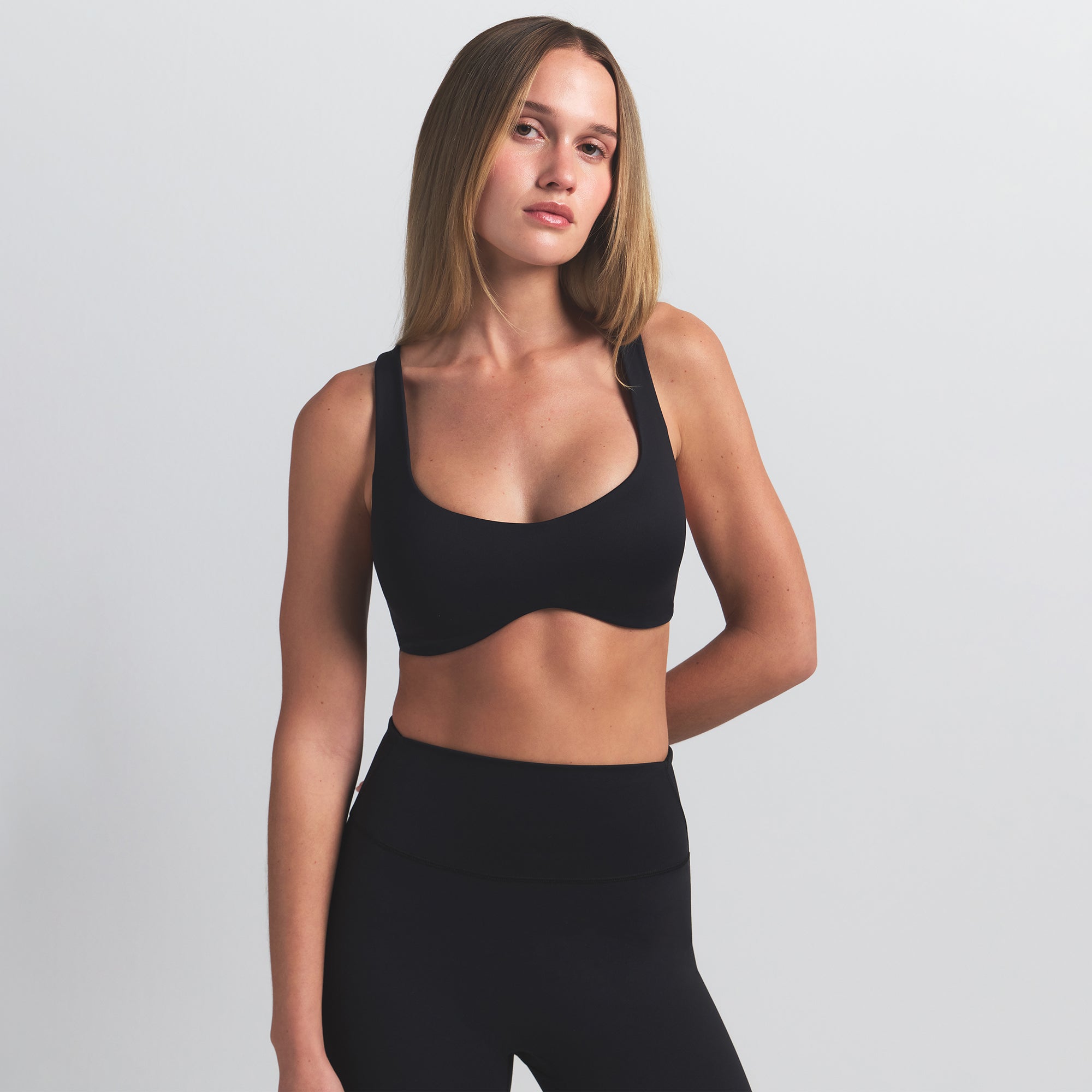 NikeSKIMS MATTE SHAPING SCOOP BRA | OBSIDIAN ON A MODEL FRONT VIEW @ | FOCUS: 0.0, 1.0, 0.9