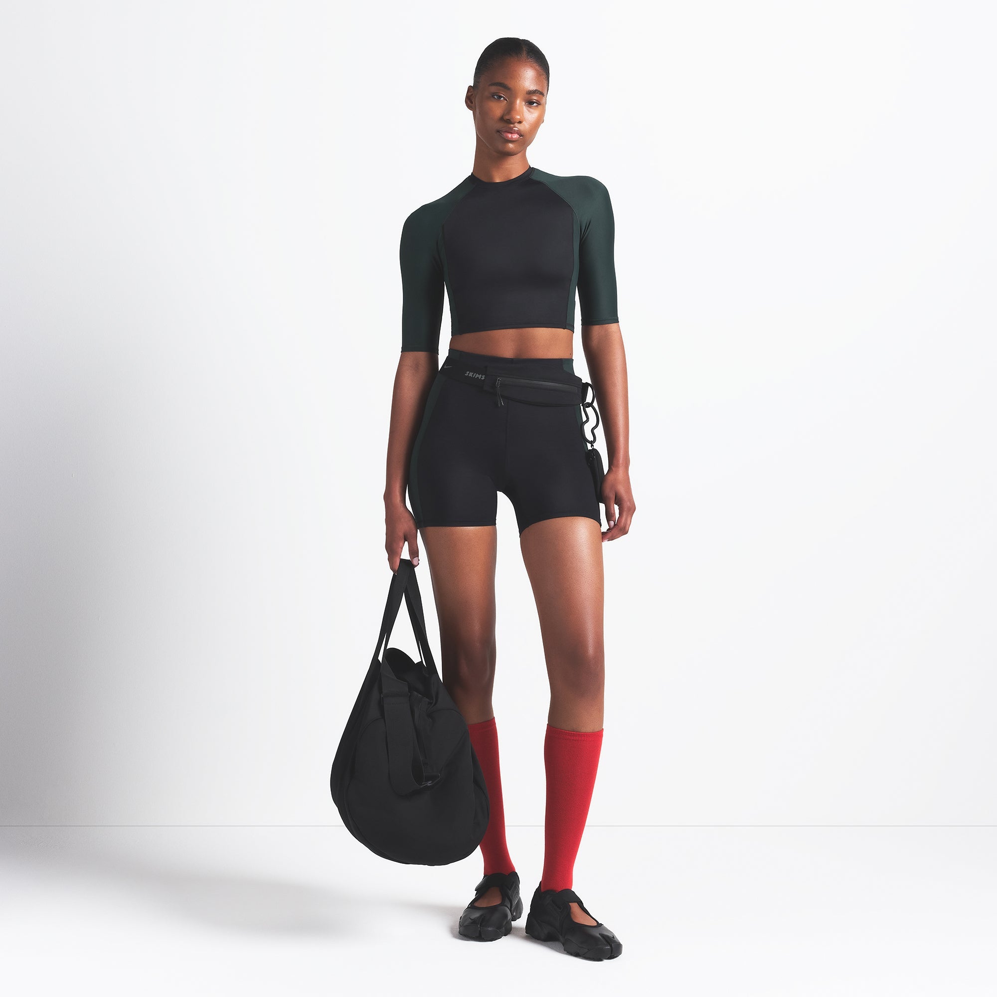 NikeSKIMS SHINE PADDED HALF SLEEVE CROP TOP | OBSIDIAN AND DARK TEAL ON A MODEL FRONT VIEW @ | FOCUS: 0.0, 1.0, 0.9