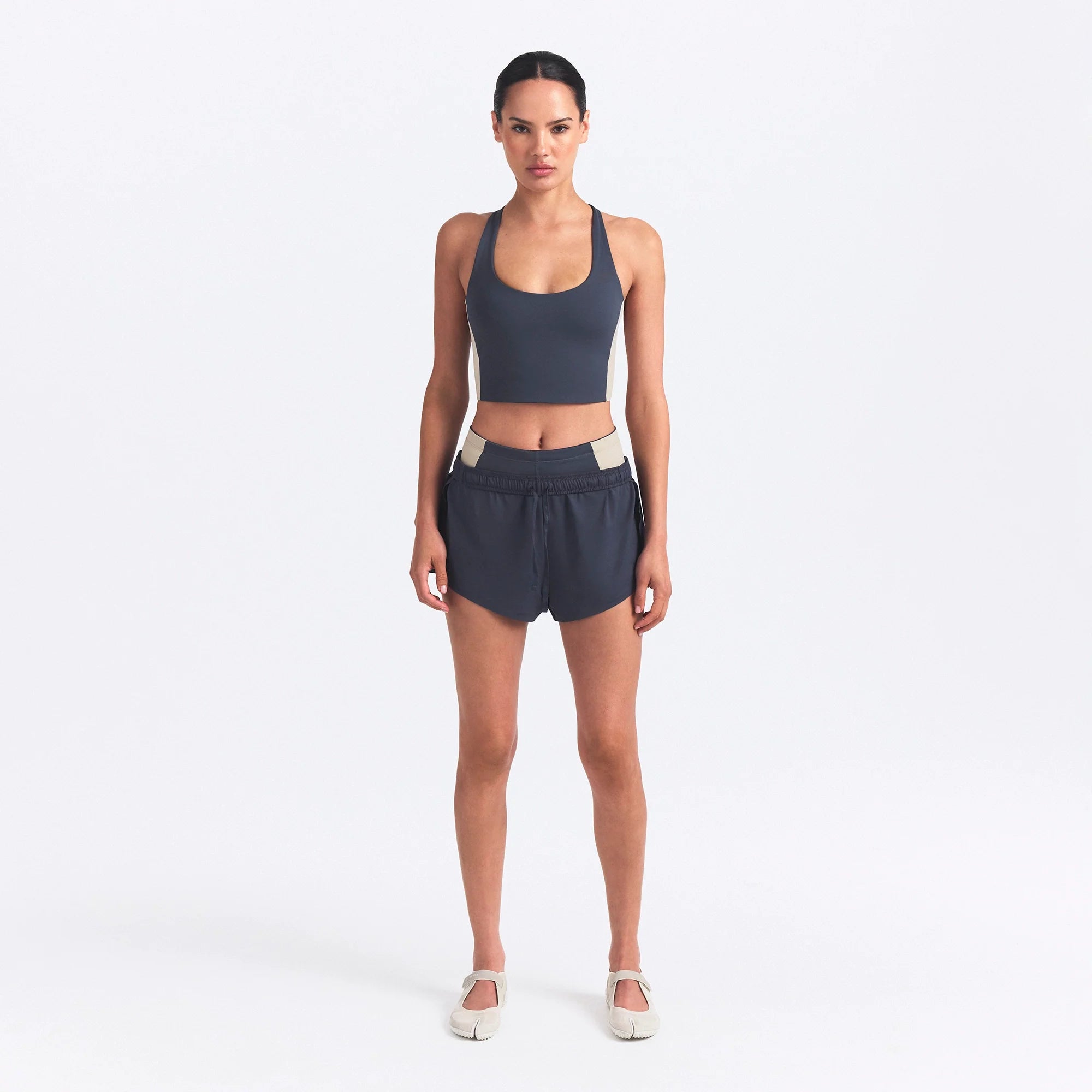 NikeSKIMS MATTE AND SHINE RACERBACK LONGLINE BRA | DEEP ROYAL/STONE ON A MODEL FRONT VIEW @ | FOCUS: 0.0, 1.0, 0.9