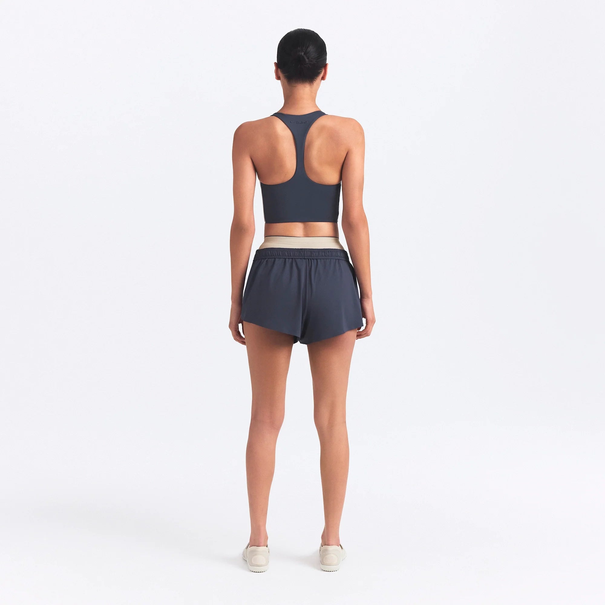NikeSKIMS MATTE AND SHINE RACERBACK LONGLINE BRA | DEEP ROYAL/STONE ON A MODEL SIDE VIEW @ | FOCUS: 0.0, 1.0, 0.9