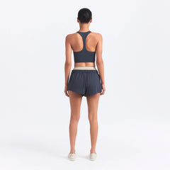 NikeSKIMS MATTE AND SHINE RACERBACK LONGLINE BRA | DEEP ROYAL/STONE ON A MODEL SIDE VIEW @ | FOCUS: 0.0, 1.0, 0.9