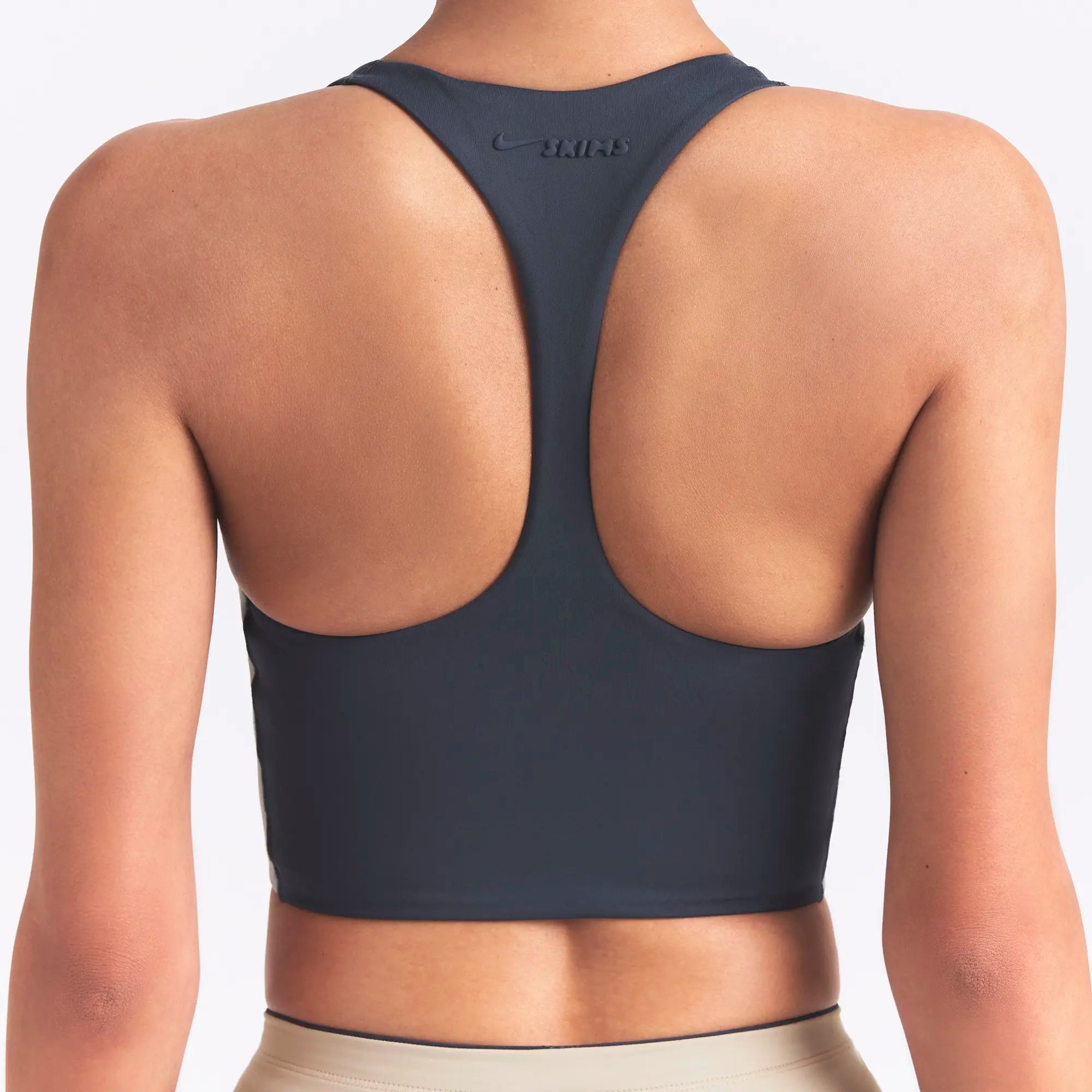 NikeSKIMS MATTE AND SHINE RACERBACK LONGLINE BRA | DEEP ROYAL/STONE ON A MODEL SIDE VIEW @ | FOCUS: 0.0, 1.0, 0.9