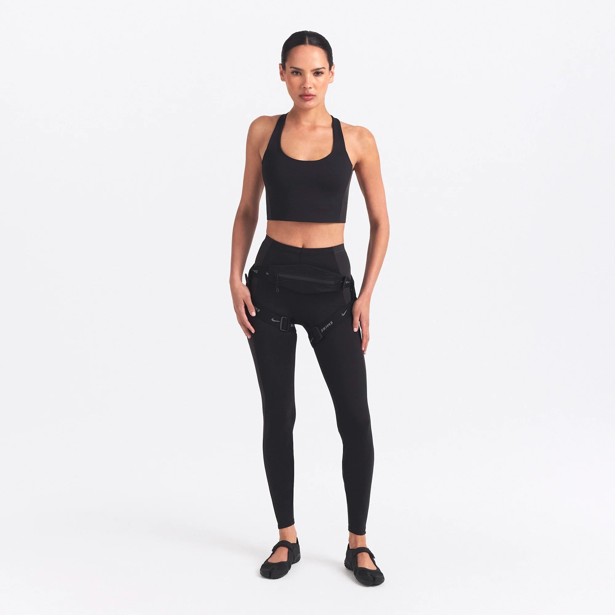 NikeSKIMS MATTE AND SHINE RACERBACK LONGLINE BRA | OBSIDIAN/IGNEOUS ON A MODEL FRONT VIEW @ | FOCUS: 0.0, 1.0, 0.9