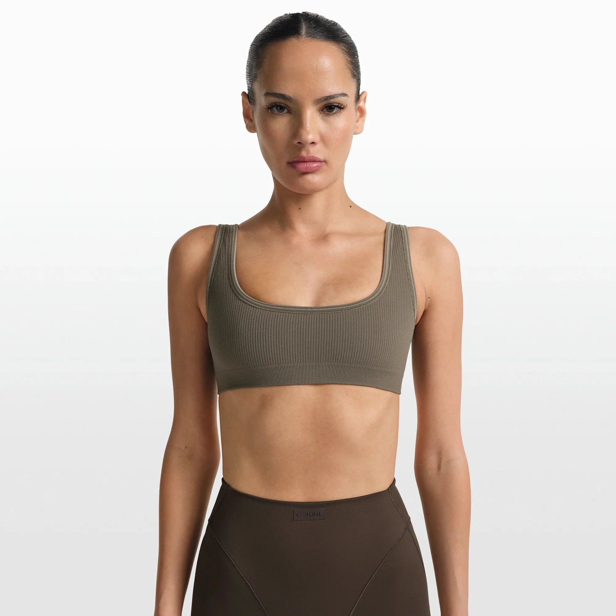 NikeSKIMS RIBBED SEAMLESS MICRO SCOOP BRA | DUSTY OAKMOSS ON A MODEL FRONT VIEW @ | FOCUS: 0.0, 1.0, 0.9