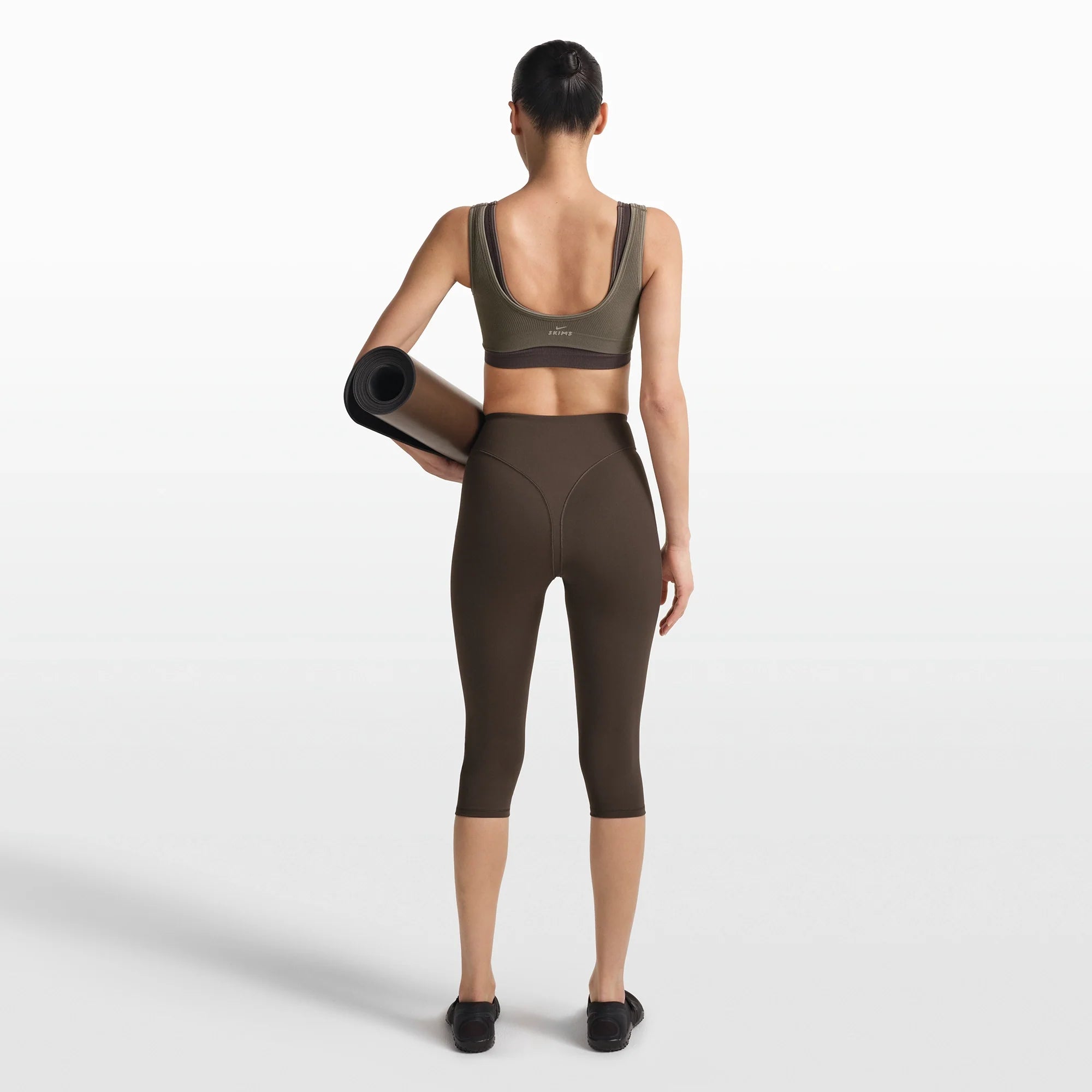 NikeSKIMS RIBBED SEAMLESS MICRO SCOOP BRA | DUSTY OAKMOSS/DUNE ON A MODEL FRONT VIEW @ | FOCUS: 0.0, 1.0, 0.9