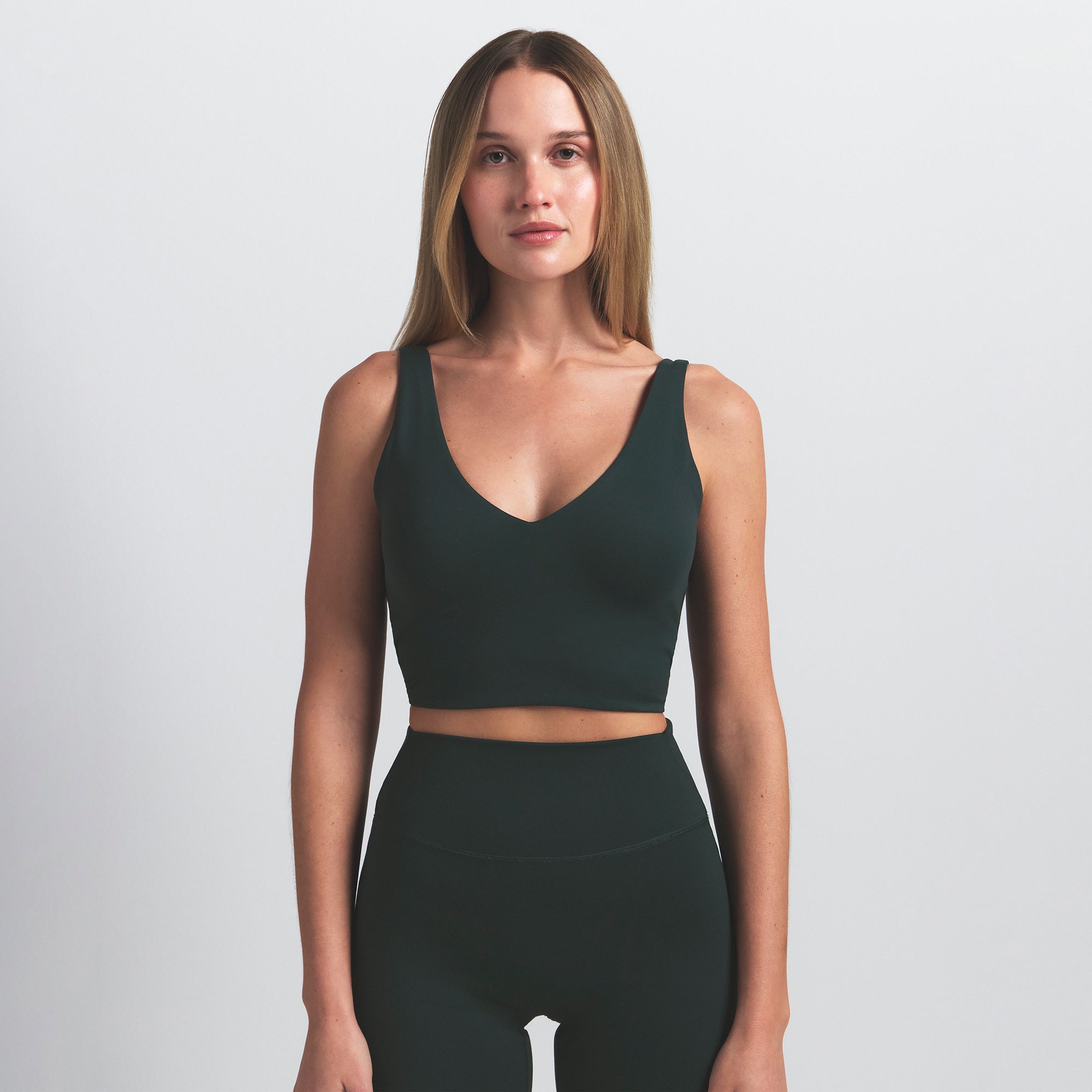 NikeSKIMS MATTE V-NECK BRA TOP | DARK TEAL ON A MODEL SIDE VIEW @ | FOCUS: 0.0, 1.0, 0.9
