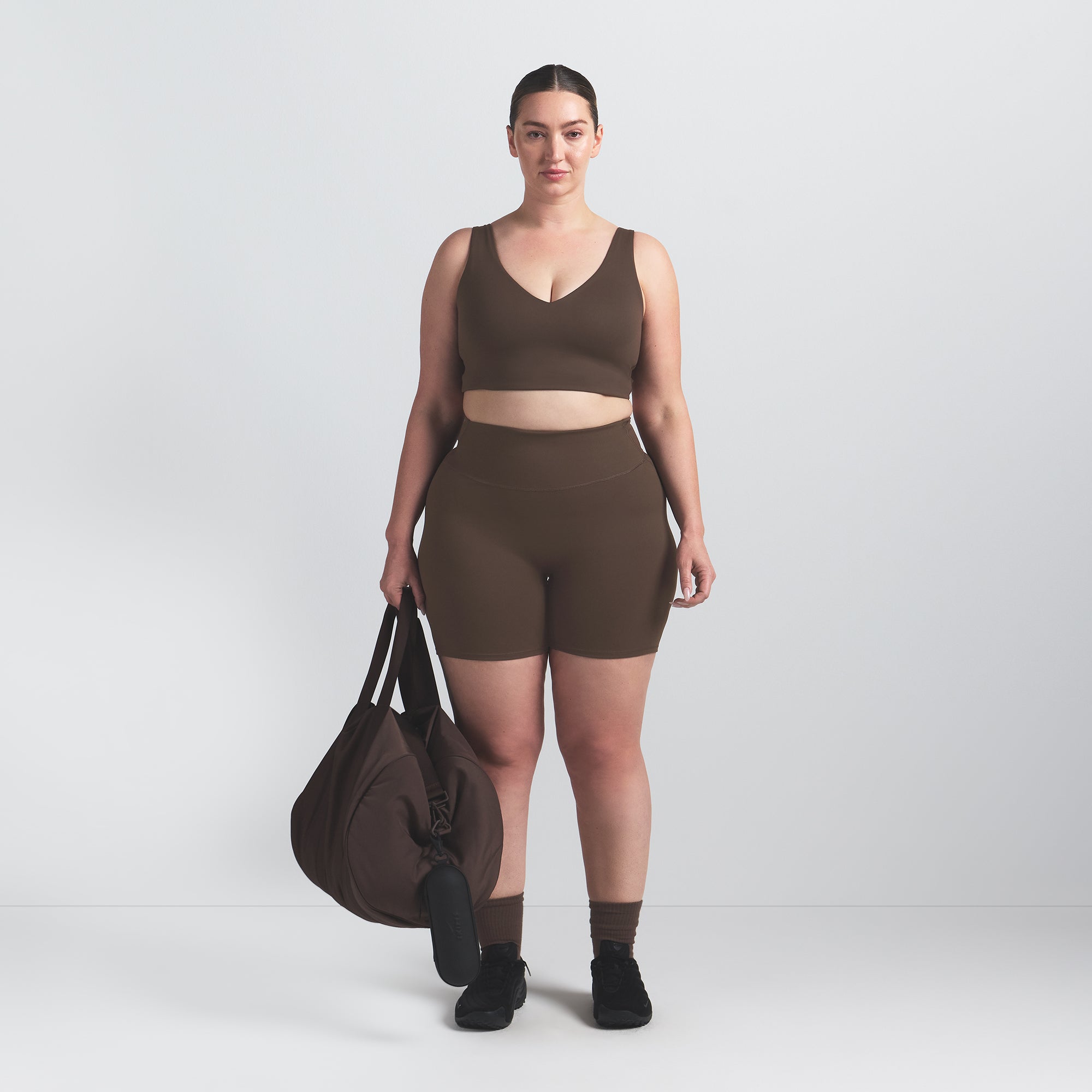 NikeSKIMS MATTE V-NECK BRA TOP | DARK SEPIA ON A MODEL FRONT VIEW