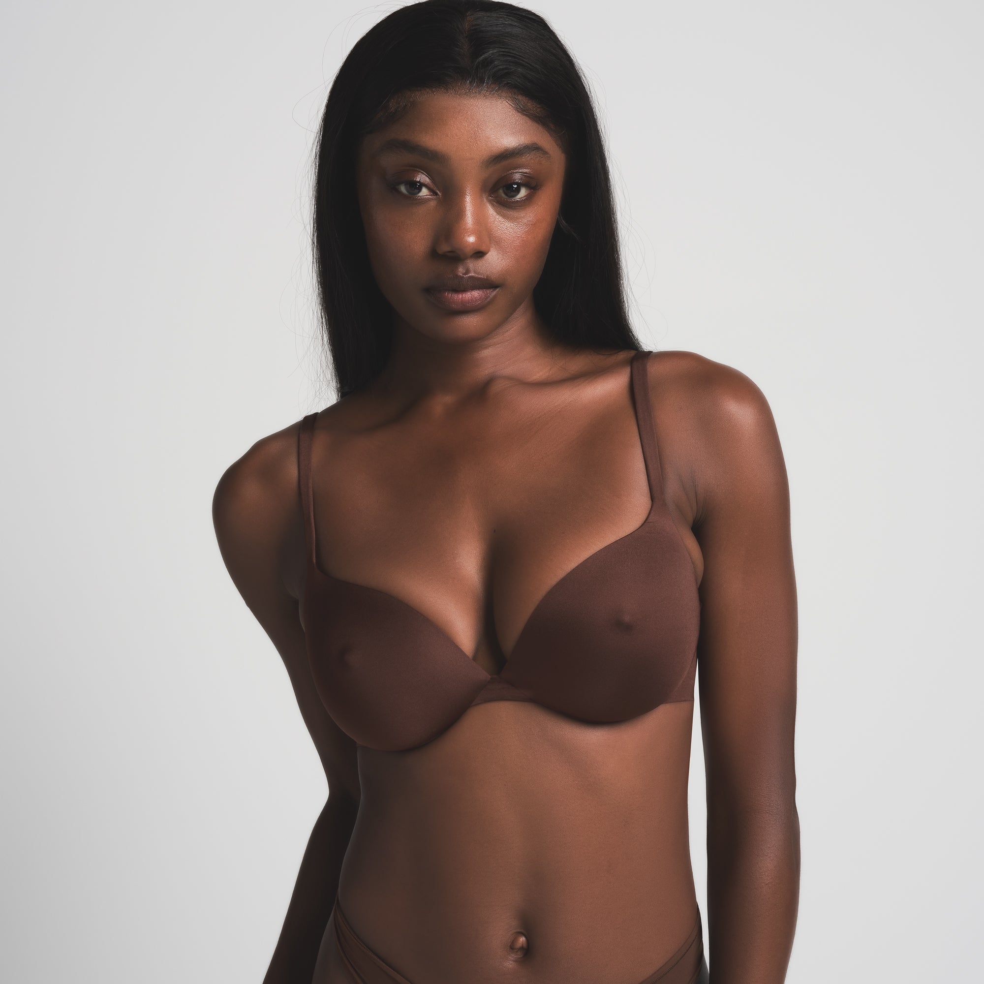 SKIMS ULTIMATE NIPPLE BRA IN COCOA ON A MODEL FRONT VIEW | FOCUS: 0.0, 1.0, 0.9