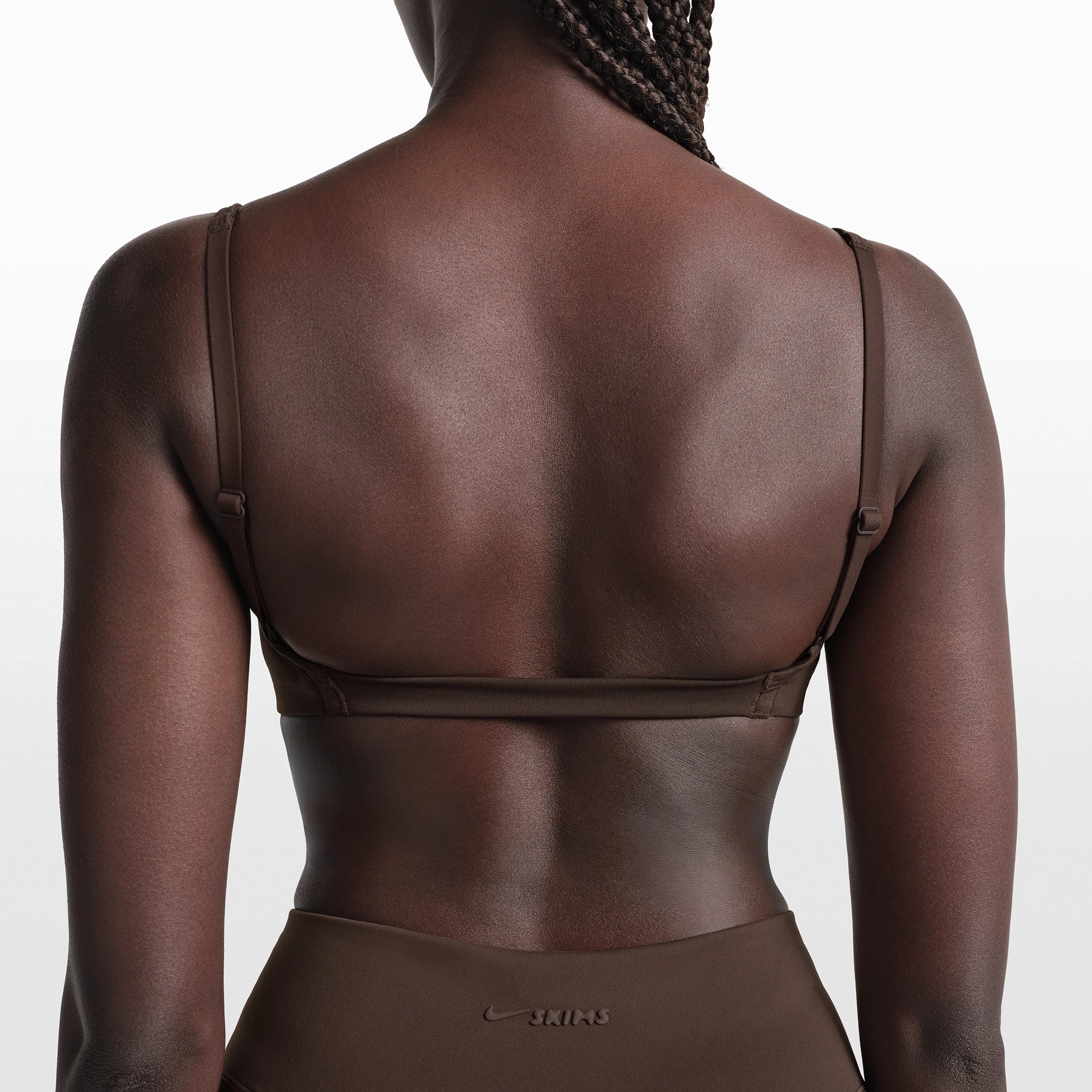NikeSKIMS MATTE MICRO BRA | DARK SEPIA ON A MODEL FRONT VIEW @ | FOCUS: 0.0, 1.0, 0.9