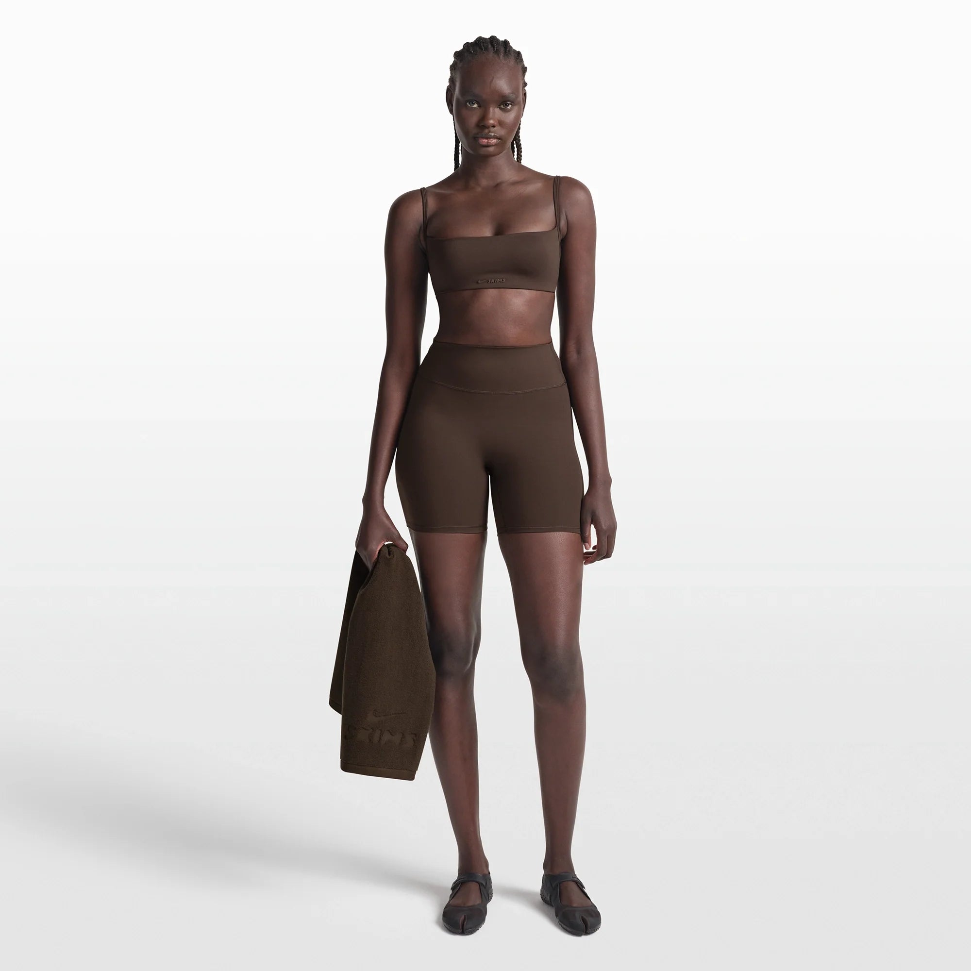 NikeSKIMS MATTE MICRO BRA | DARK SEPIA ON A MODEL FRONT VIEW @ | FOCUS: 0.0, 1.0, 0.9