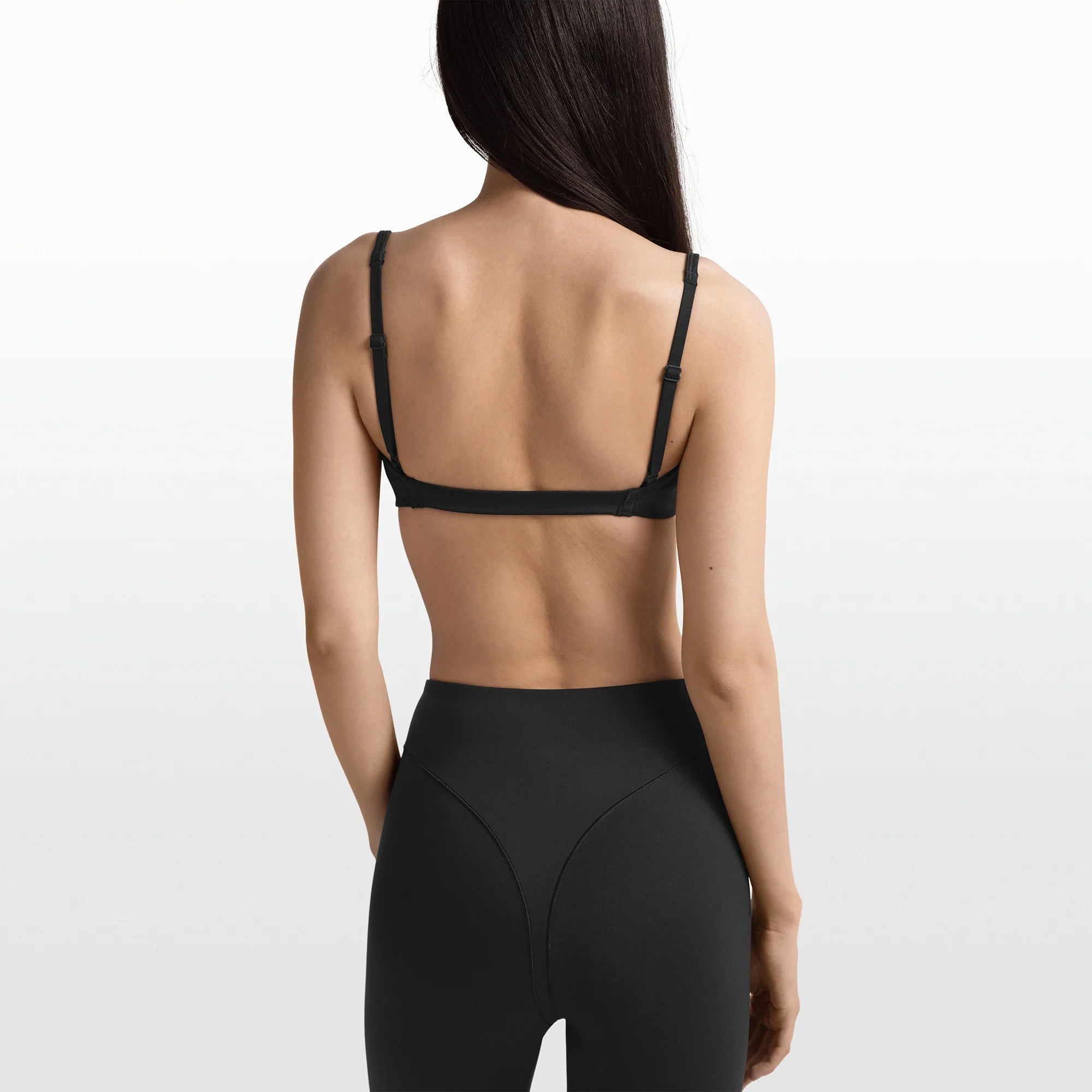 NikeSKIMS MATTE MICRO BRA | OBSIDIAN ON A MODEL FRONT VIEW @ | FOCUS: 0.0, 1.0, 0.9