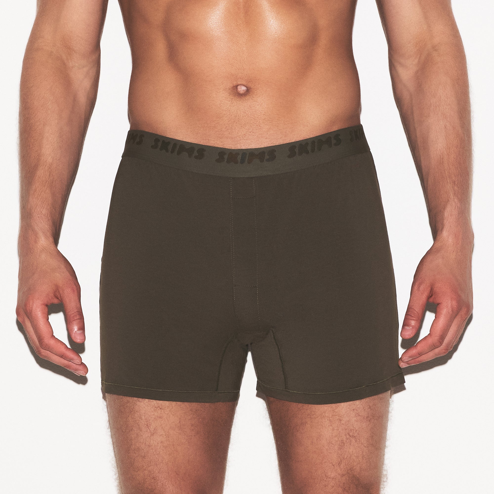 SKIMS STRETCH MENS KNIT BOXER | LODEN ON A MODEL SIDE VIEW @ | FOCUS: 0.0, 1.0, 0.9