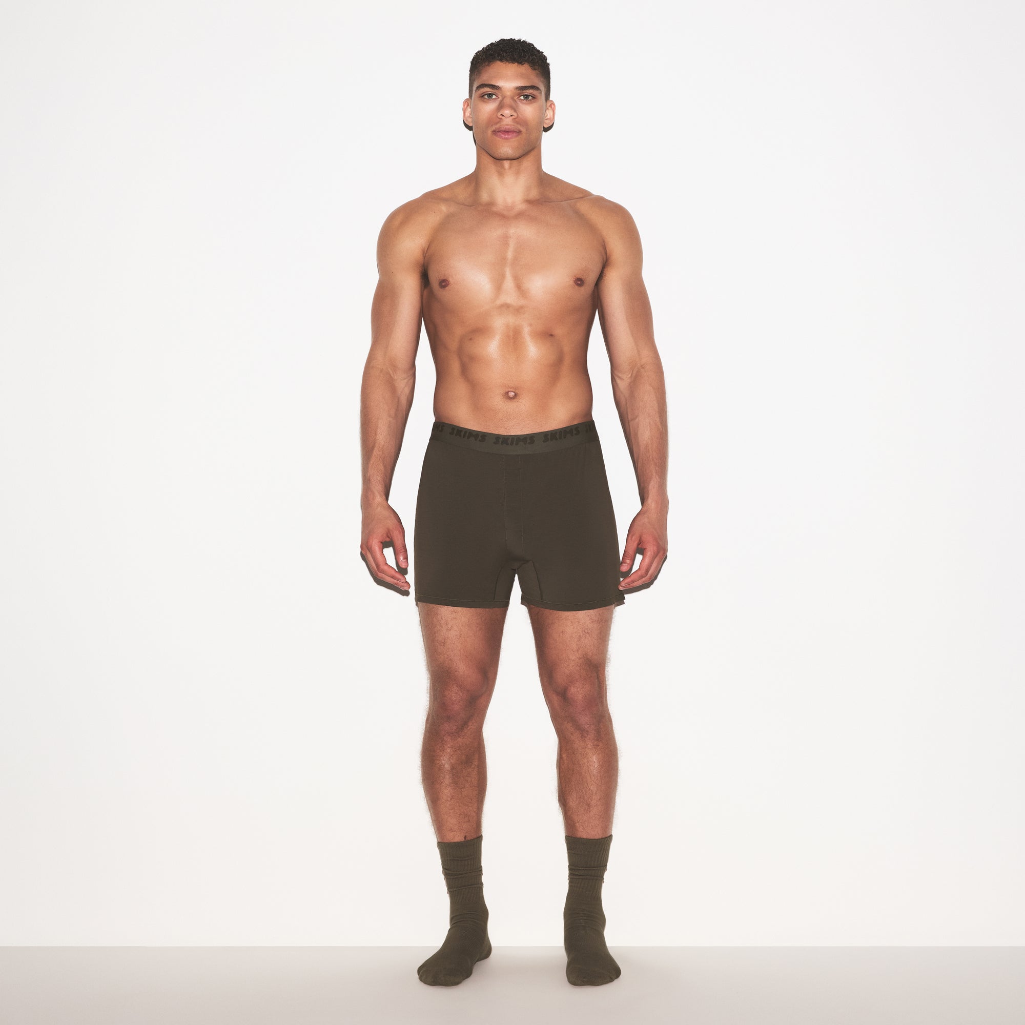 SKIMS STRETCH MENS KNIT BOXER | LODEN ON A MODEL FRONT VIEW @ | FOCUS: 0.0, 1.0, 0.9