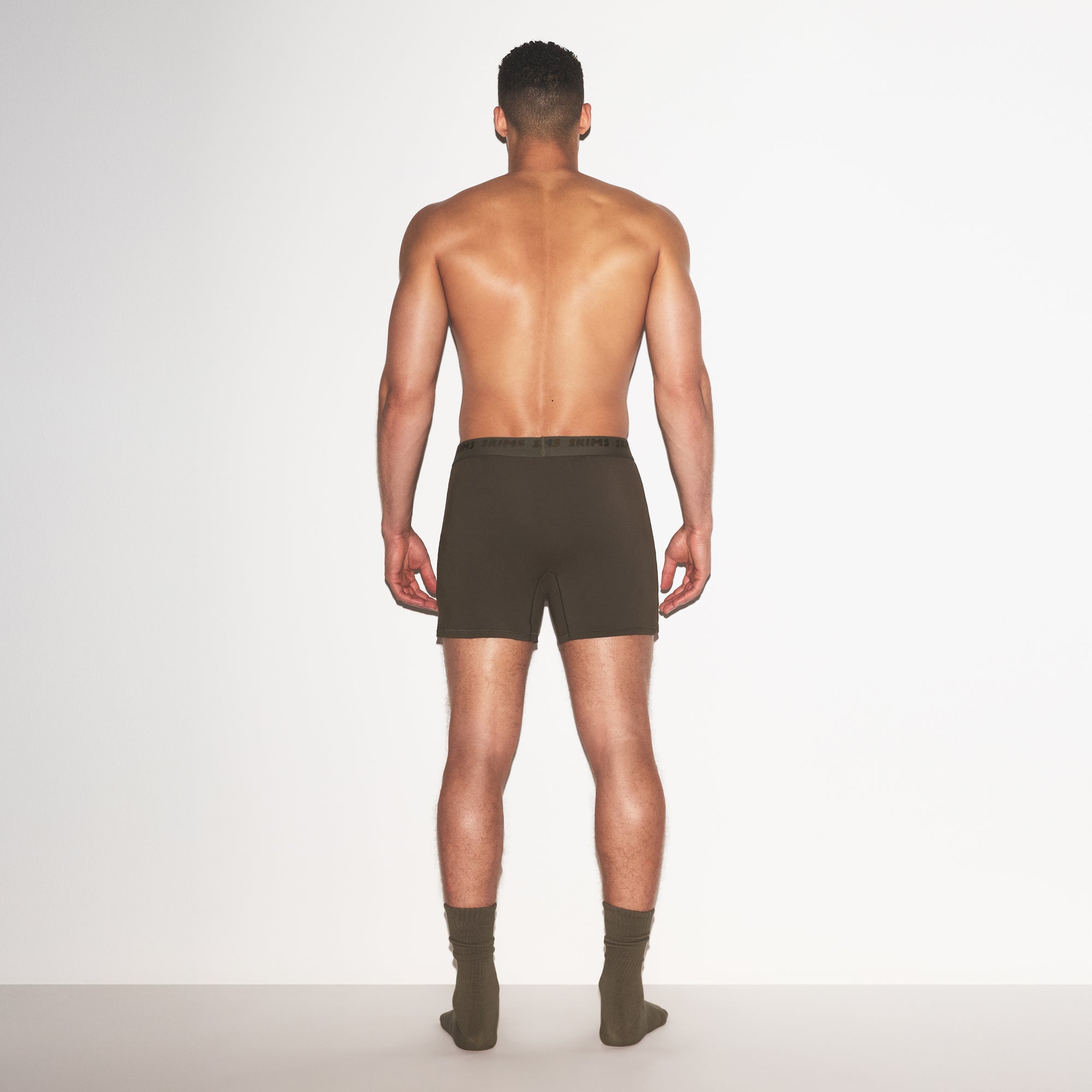 SKIMS STRETCH MENS KNIT BOXER | LODEN ON A MODEL FRONT VIEW @ | FOCUS: 0.0, 1.0, 0.9