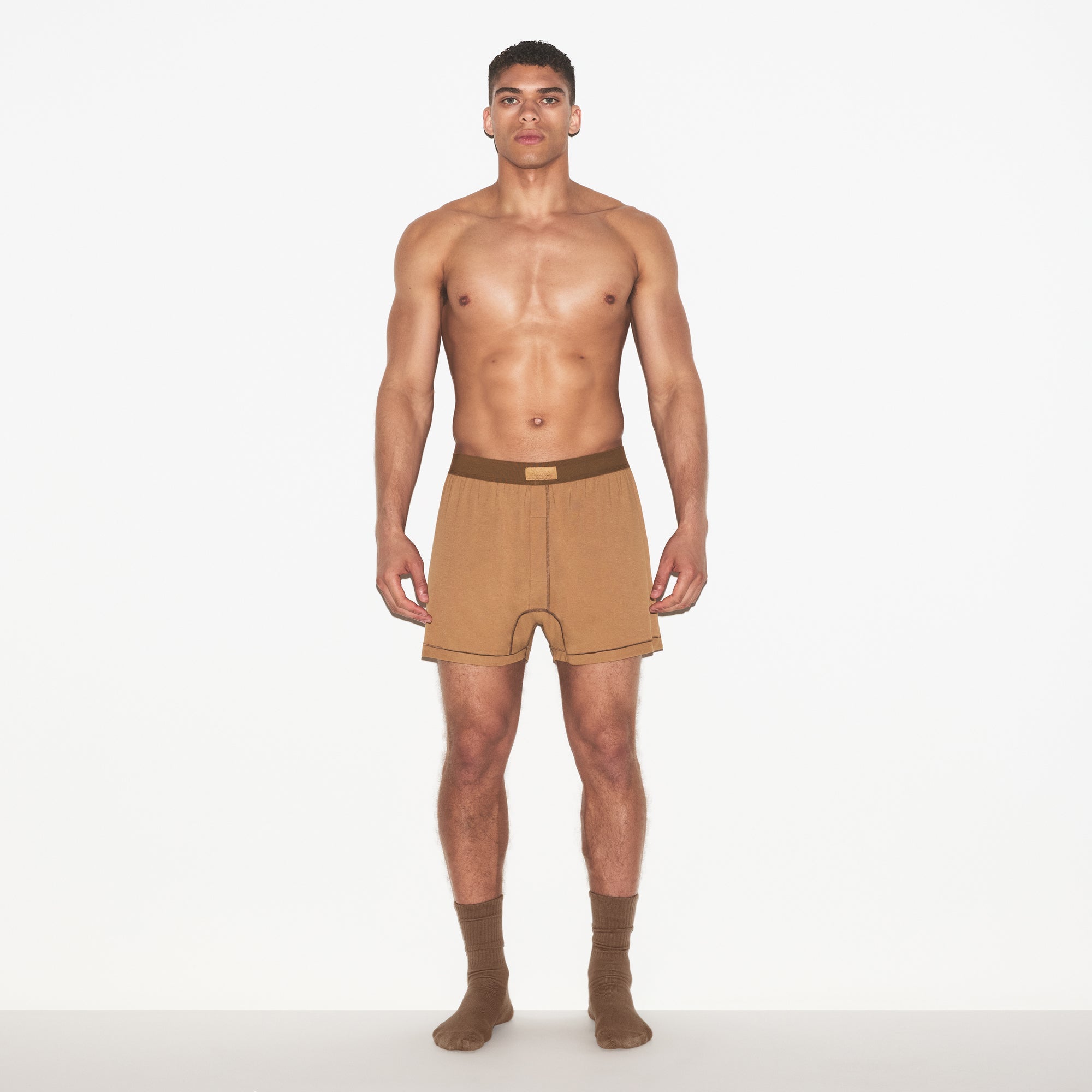SKIMS COTTON MENS KNIT BOXER | RUSSET ON A MODEL FRONT VIEW | FOCUS: 0.0, 1.0, 0.9