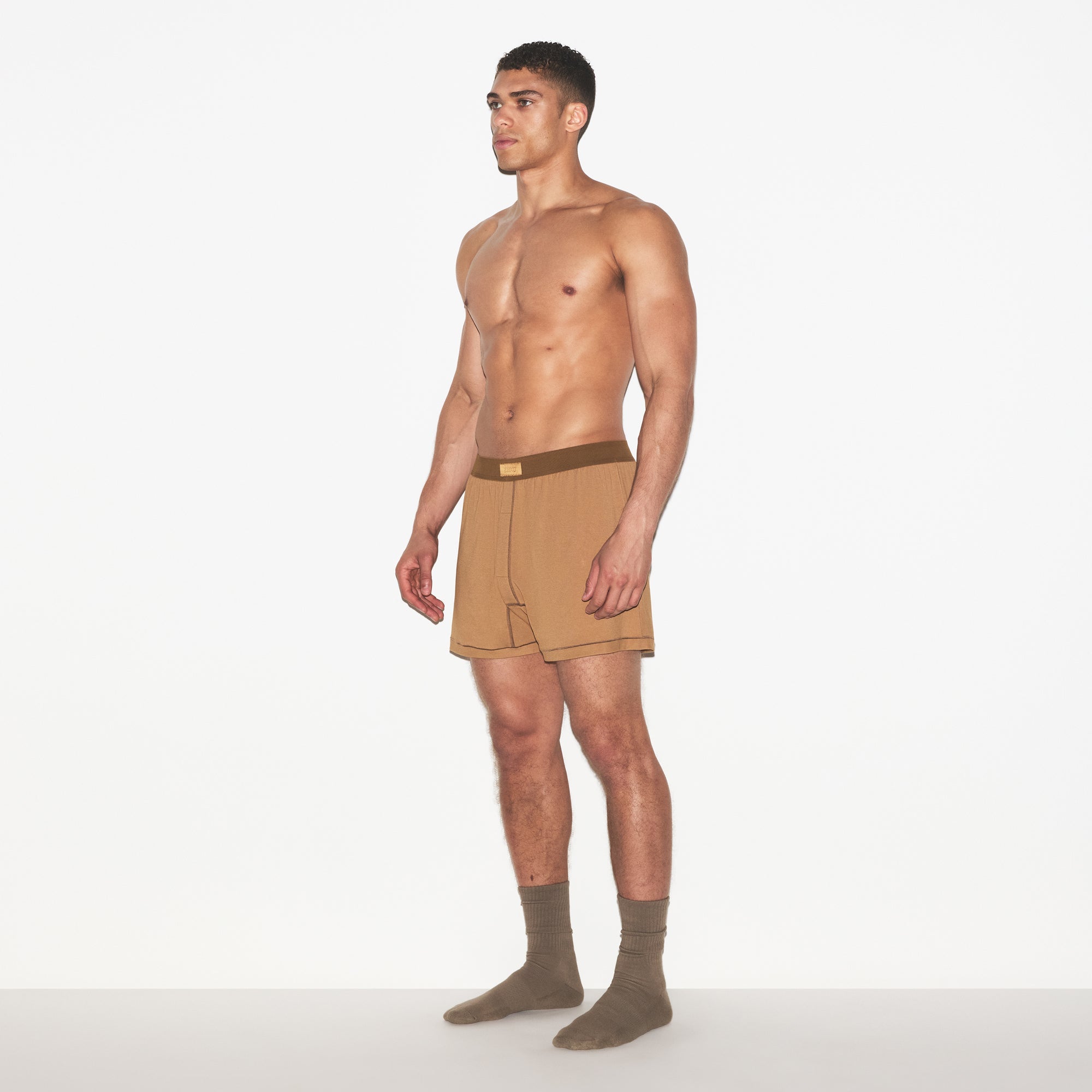 SKIMS COTTON MENS KNIT BOXER | RUSSET ON A MODEL FRONT VIEW | FOCUS: 0.0, 1.0, 0.9