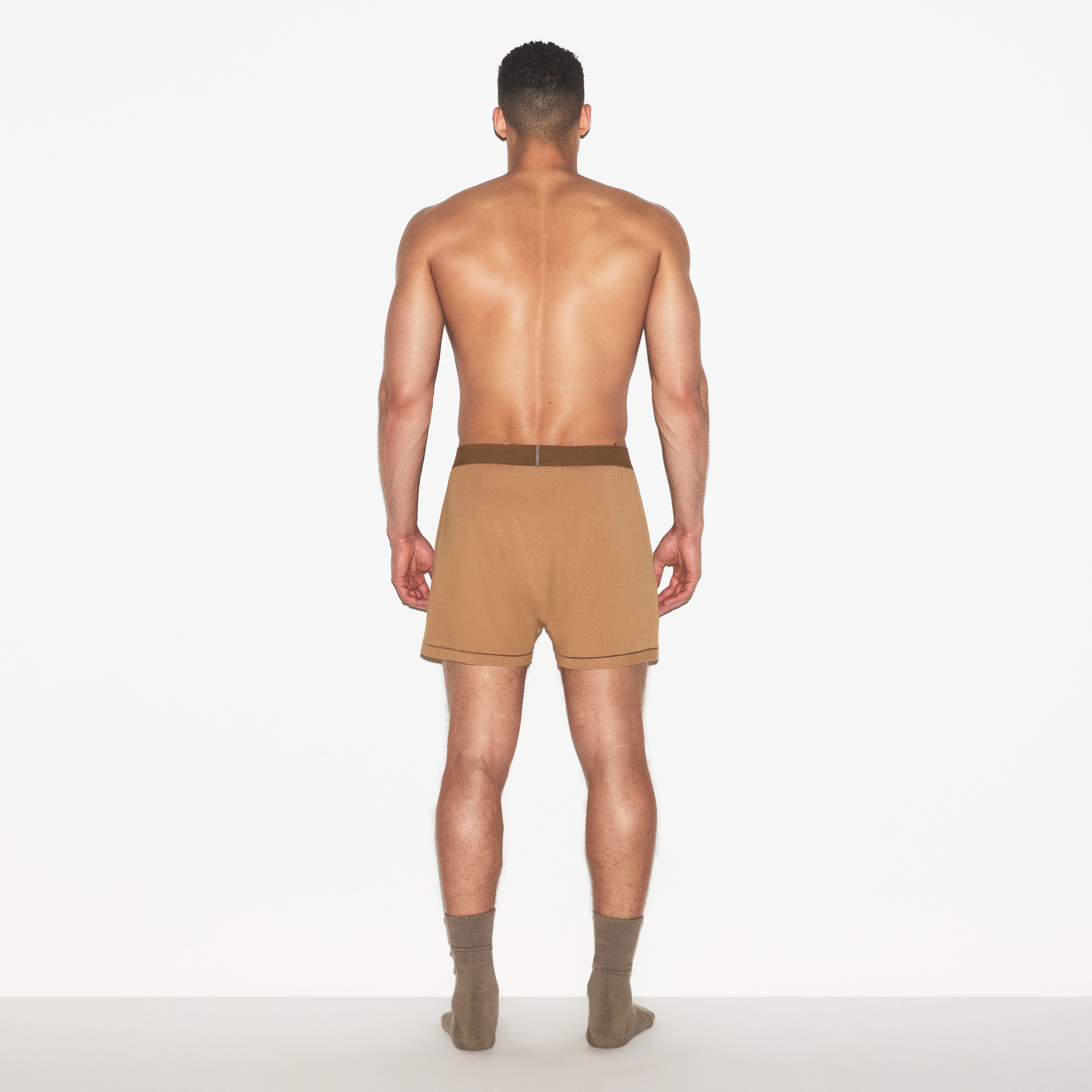 SKIMS COTTON MENS KNIT BOXER | RUSSET ON A MODEL FRONT VIEW | FOCUS: 0.0, 1.0, 0.9