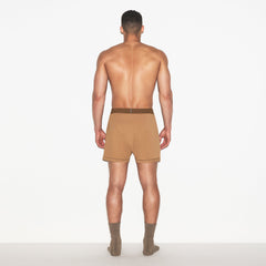 SKIMS COTTON MENS KNIT BOXER | RUSSET ON A MODEL FRONT VIEW | FOCUS: 0.0, 1.0, 0.9