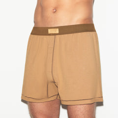 SKIMS COTTON MENS KNIT BOXER | RUSSET ON A MODEL SIDE VIEW | FOCUS: 0.0, 1.0, 0.9