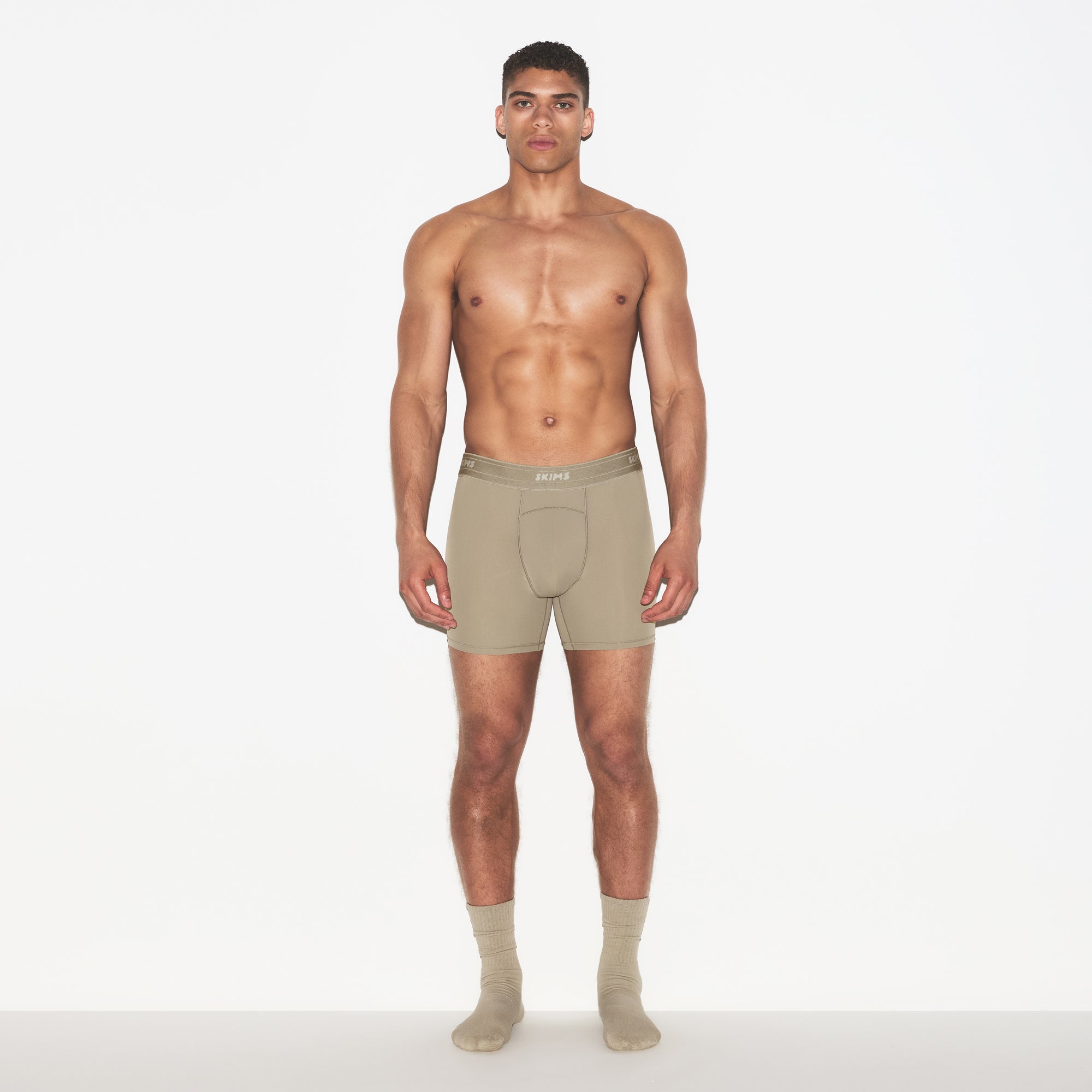 SKIMS SPORT MENS 5" BOXER BRIEF 3-PACK | DUNE MULTI ON A MODEL FRONT VIEW | FOCUS: 0.0, 1.0, 0.9