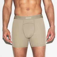 SKIMS SPORT MENS 5 INCH BOXER BRIEF 3-PACK | DUNE MULTI ON A MODEL SIDE VIEW | FOCUS: 0.0, 1.0, 0.9