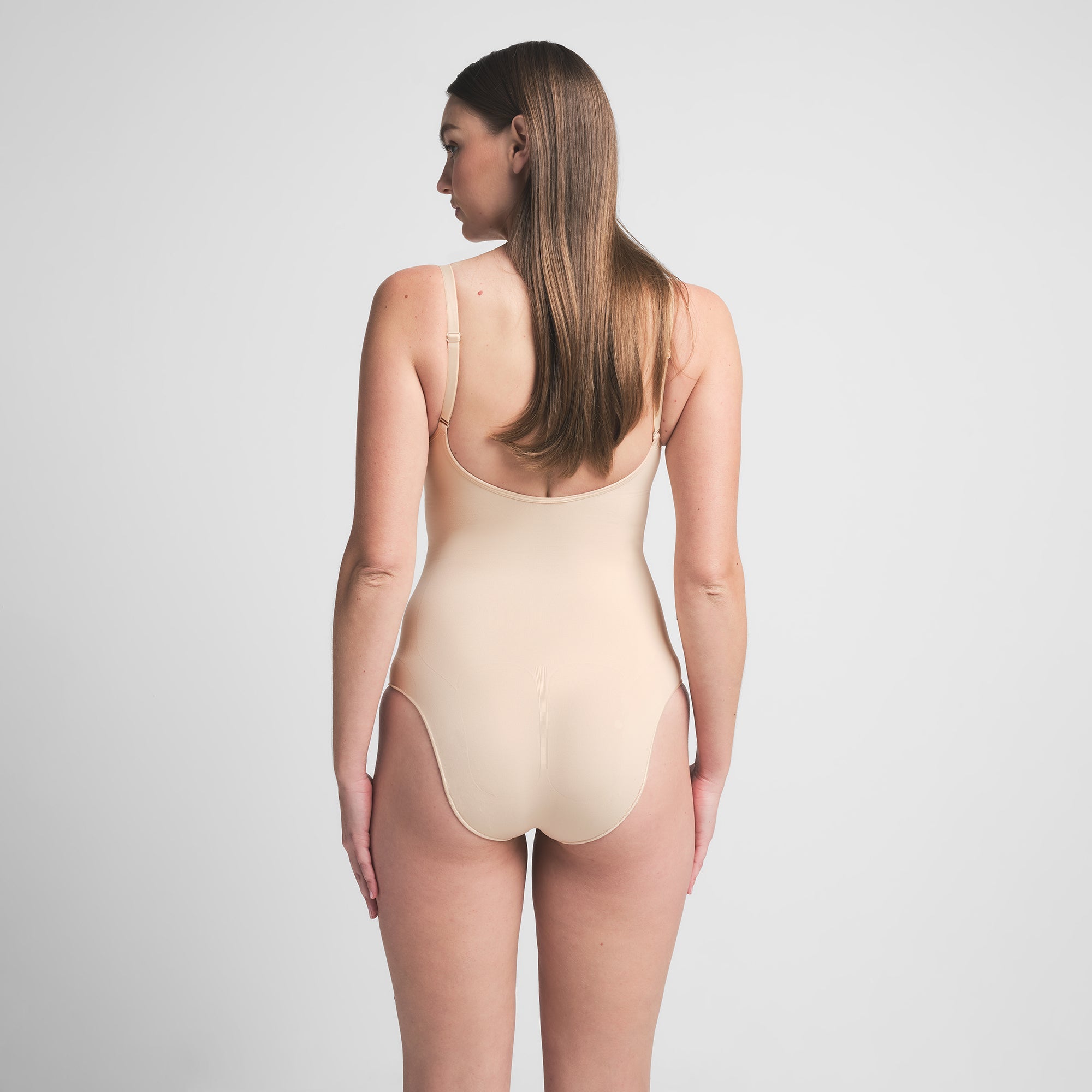 SEAMLESS SCULPT BRIEF BODYSUIT | SAND ON A MODEL BACK VIEW