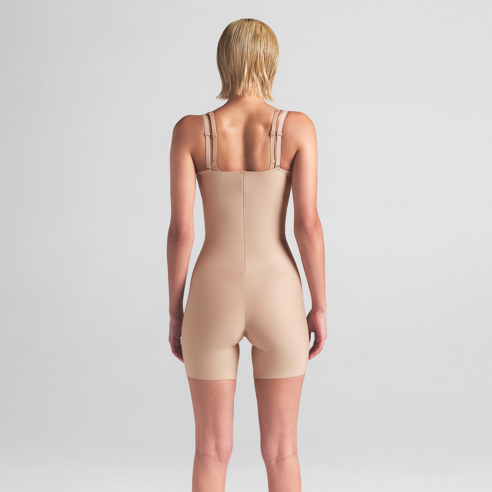 SKIMS BODY CORE SCULPT OPEN BUST MID THIGH BODYSUIT | CLAY ON A MODEL BACK VIEW