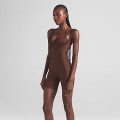 SKIMS BODY CORE SCULPT OPEN BUST MID THIGH BODYSUIT | COCOA ON A MODEL SIDE VIEW