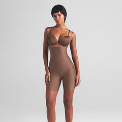 SKIMS BODY CORE SCULPT OPEN BUST MID THIGH BODYSUIT | JASPER ON A MODEL FRONT VIEW