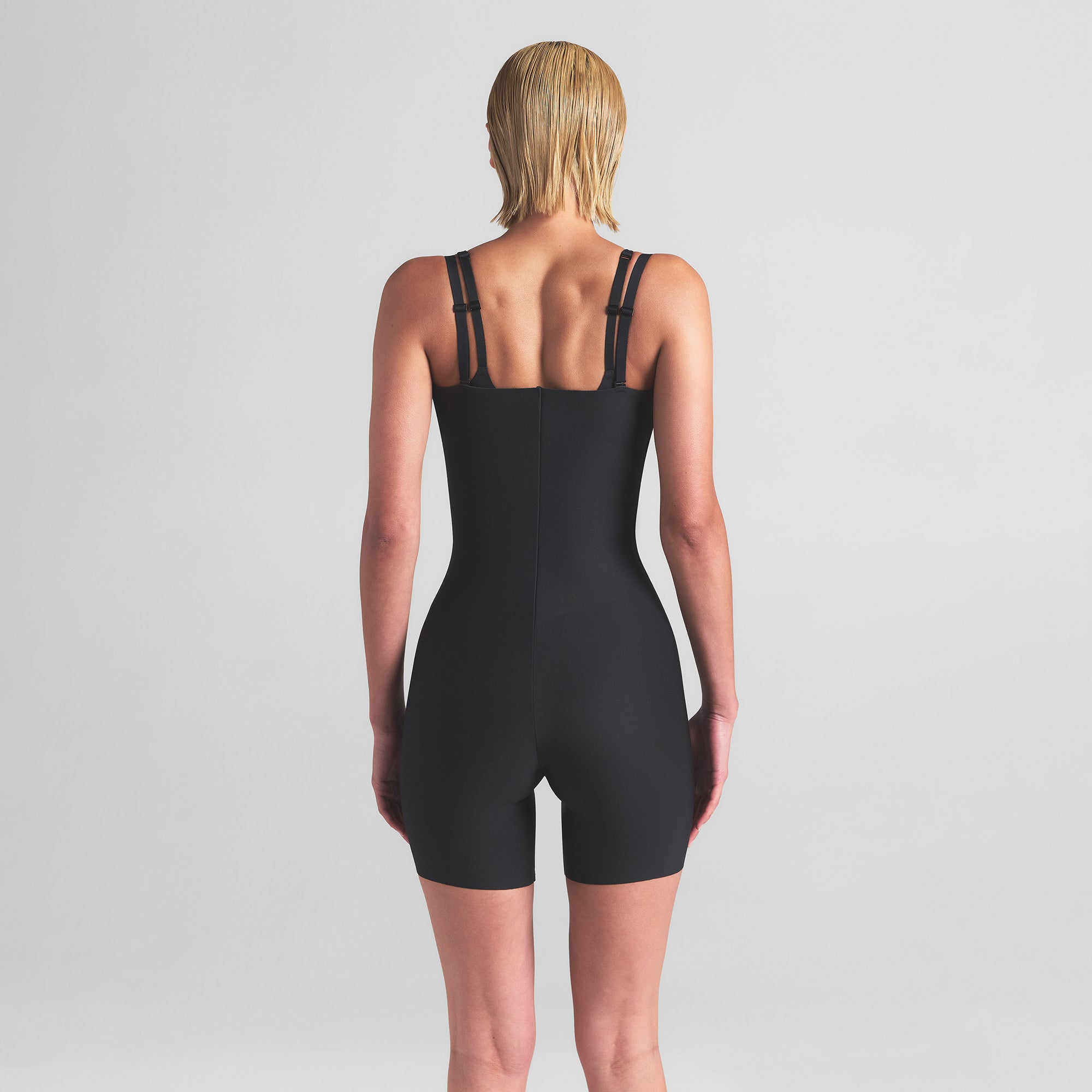 SKIMS BODY CORE SCULPT OPEN BUST MID THIGH BODYSUIT | ONYX ON A MODEL BACK VIEW