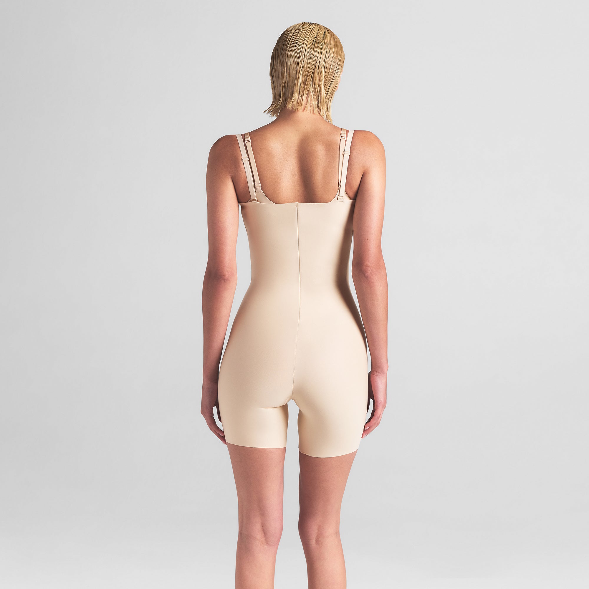 SKIMS BODY CORE SCULPT OPEN BUST MID THIGH BODYSUIT | SAND ON A MODEL BACK VIEW