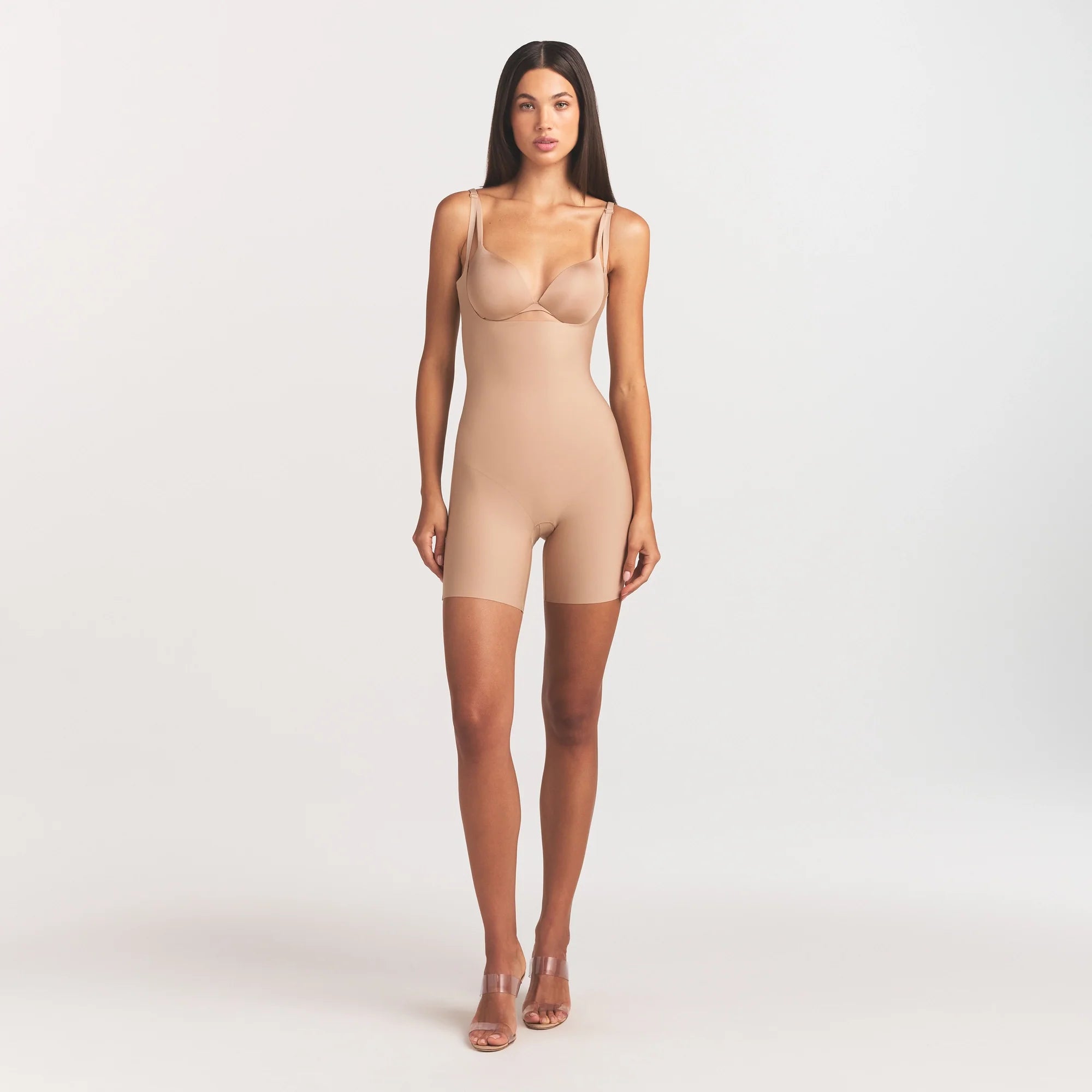 SKIMS BODY CORE SCULPT BACK SMOOTHING OPEN BUST MID THIGH BODYSUIT | CLAY ON A MODEL FRONT VIEW @