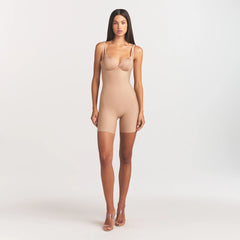 SKIMS BODY CORE SCULPT BACK SMOOTHING OPEN BUST MID THIGH BODYSUIT | CLAY ON A MODEL FRONT VIEW @
