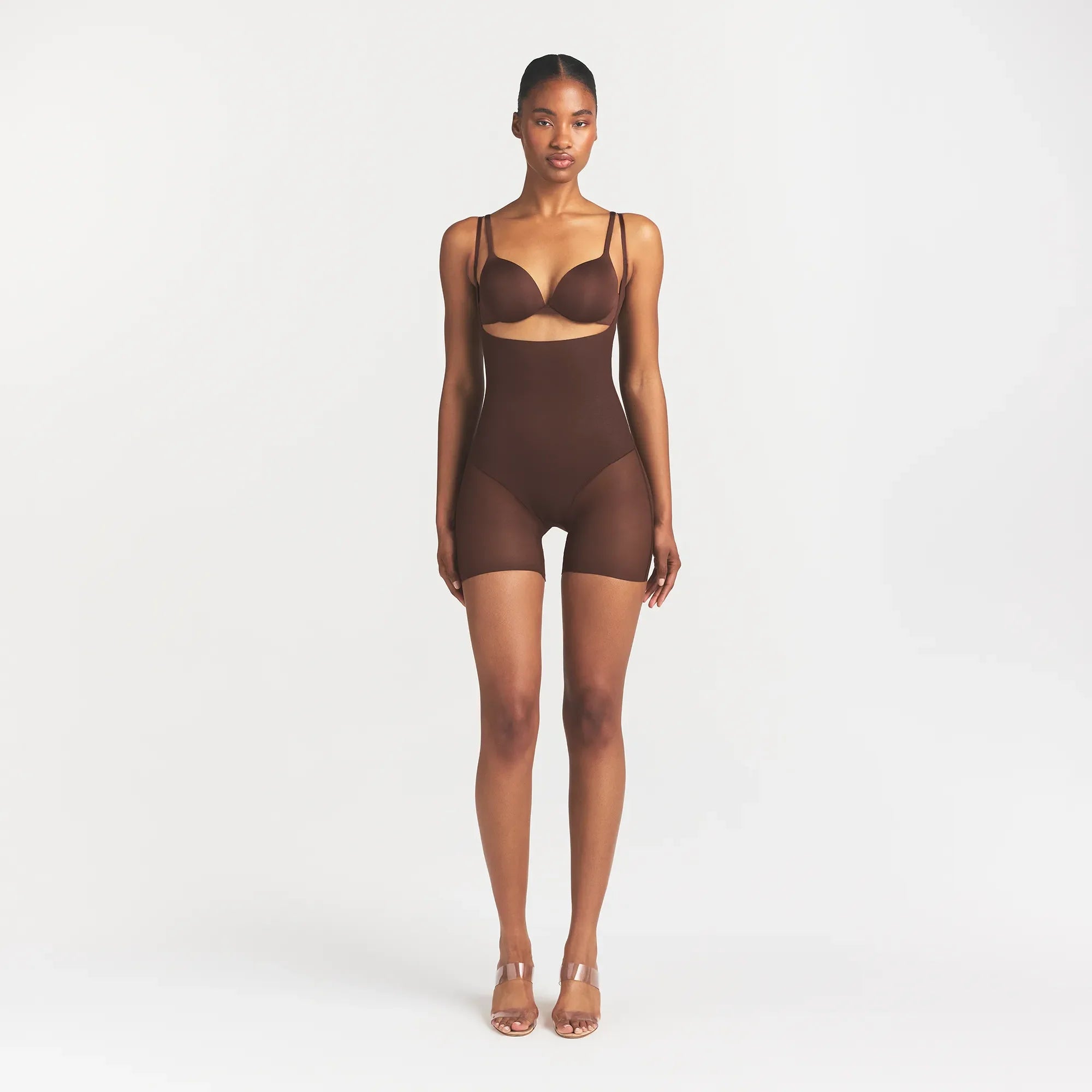 SKIMS BODY CORE SCULPT BACK SMOOTHING OPEN BUST MID THIGH BODYSUIT | COCOA ON A MODEL FRONT VIEW @