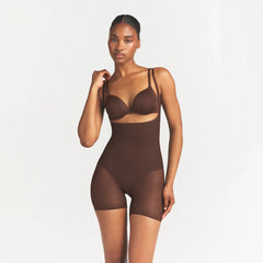 SKIMS BODY CORE SCULPT BACK SMOOTHING OPEN BUST MID THIGH BODYSUIT | COCOA ON A MODEL FRONT VIEW @