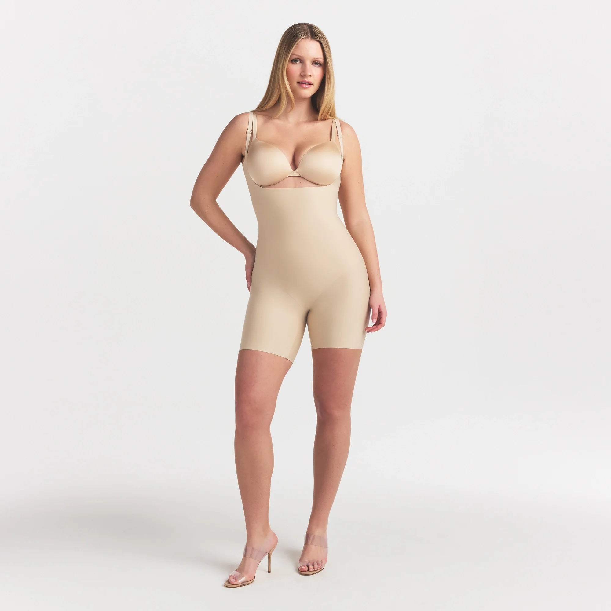 SKIMS BODY CORE SCULPT BACK SMOOTHING OPEN BUST MID THIGH BODYSUIT | SAND ON A MODEL FRONT VIEW @
