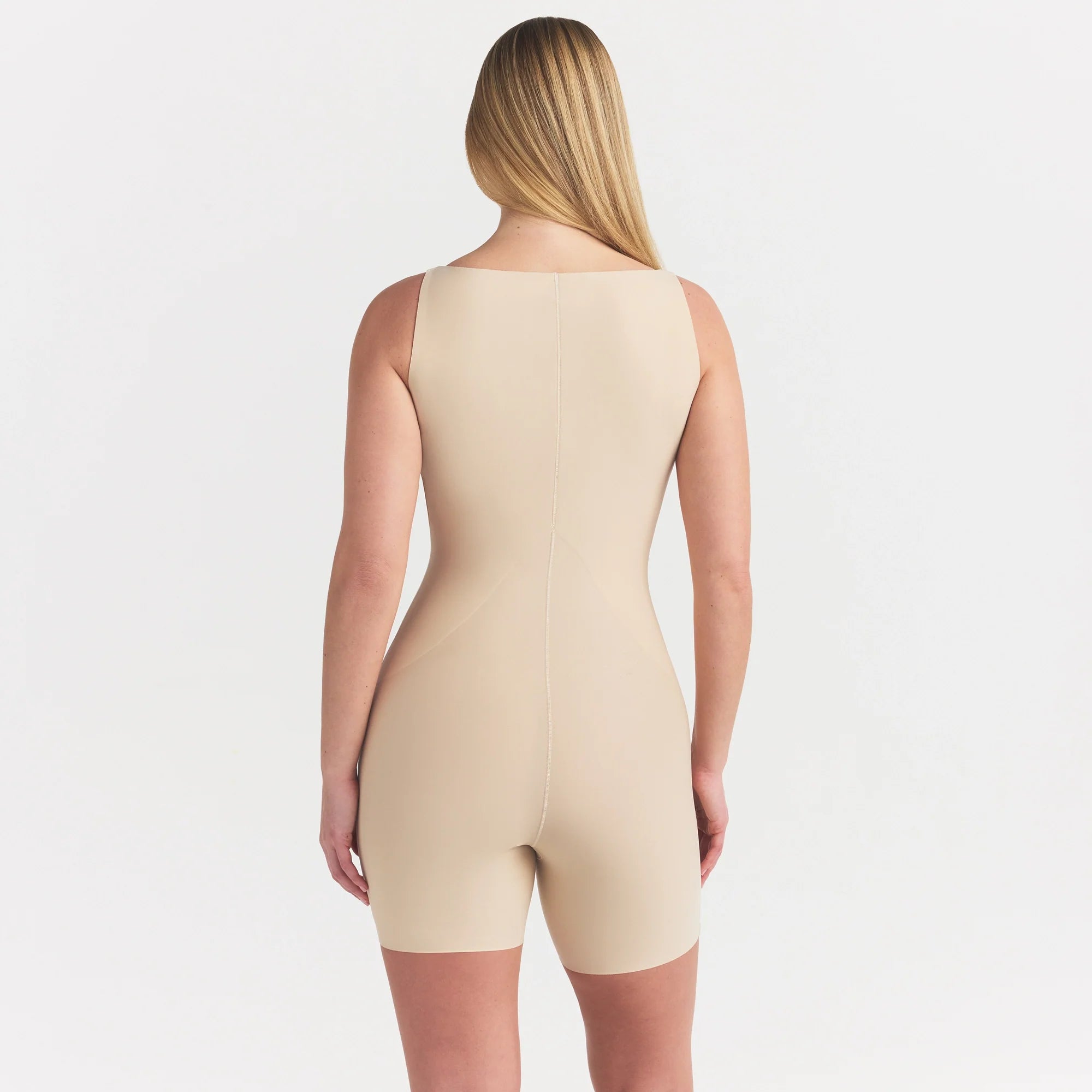 SKIMS BODY CORE SCULPT BACK SMOOTHING OPEN BUST MID THIGH BODYSUIT | SAND ON A MODEL SIDE VIEW @