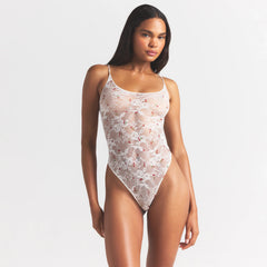 STRETCH LACE THONG BODYSUIT | IVORY CHERRY PRINT ON A MODEL SIDE VIEW @ | FOCUS: 0.0, 1.0, 0.9