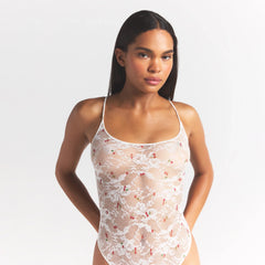 STRETCH LACE THONG BODYSUIT | IVORY CHERRY PRINT ON A MODEL SIDE VIEW @ | FOCUS: 0.0, 1.0, 0.9