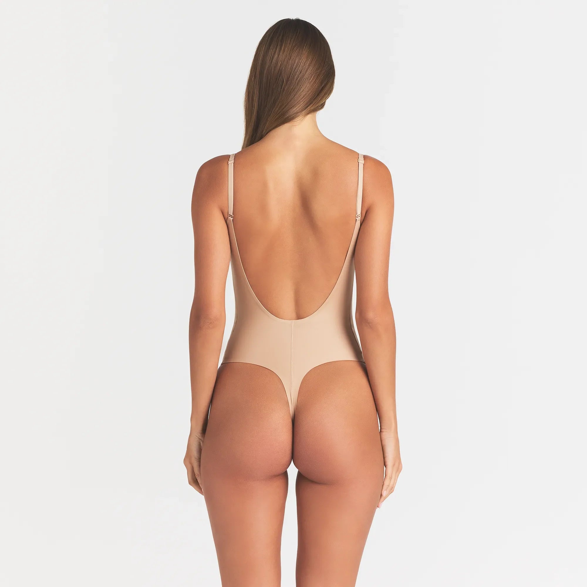 SKIMS BODY SCOOP LOW BACK THONG BODYSUIT | CLAY ON A MODEL BACK VIEW @