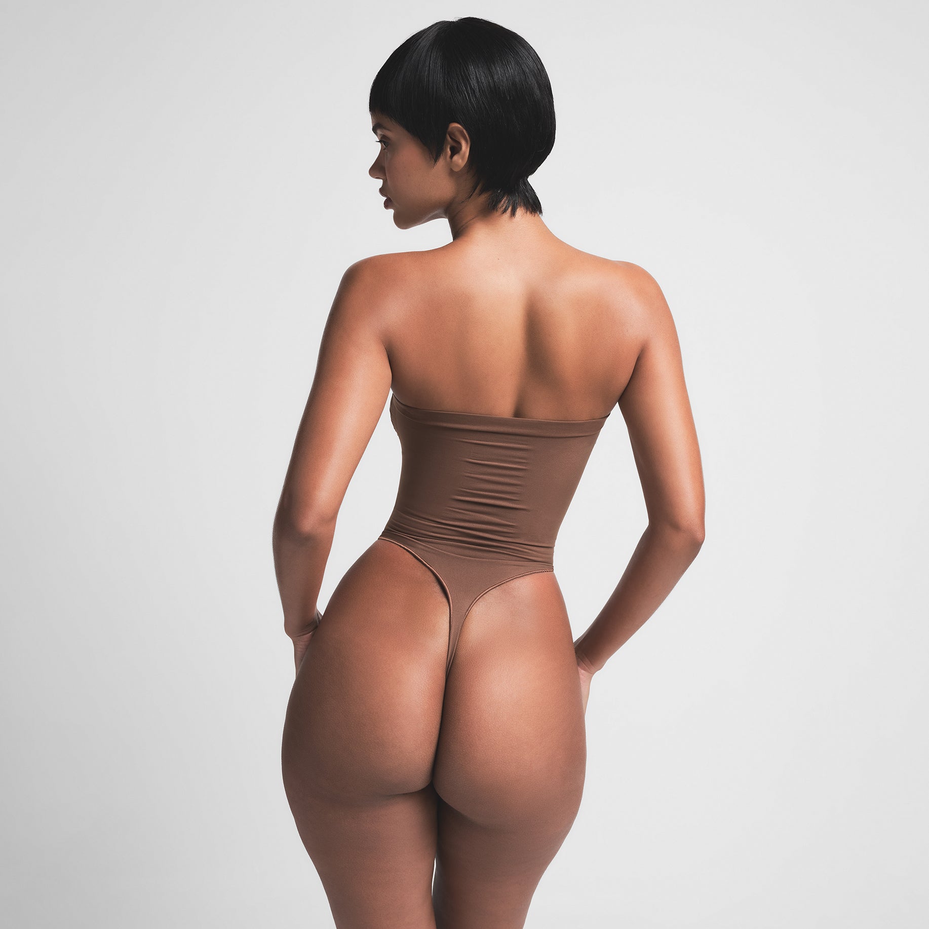 SEAMLESS SCULPT STRAPLESS THONG BODYSUIT | JASPER ON A MODEL BACK VIEW