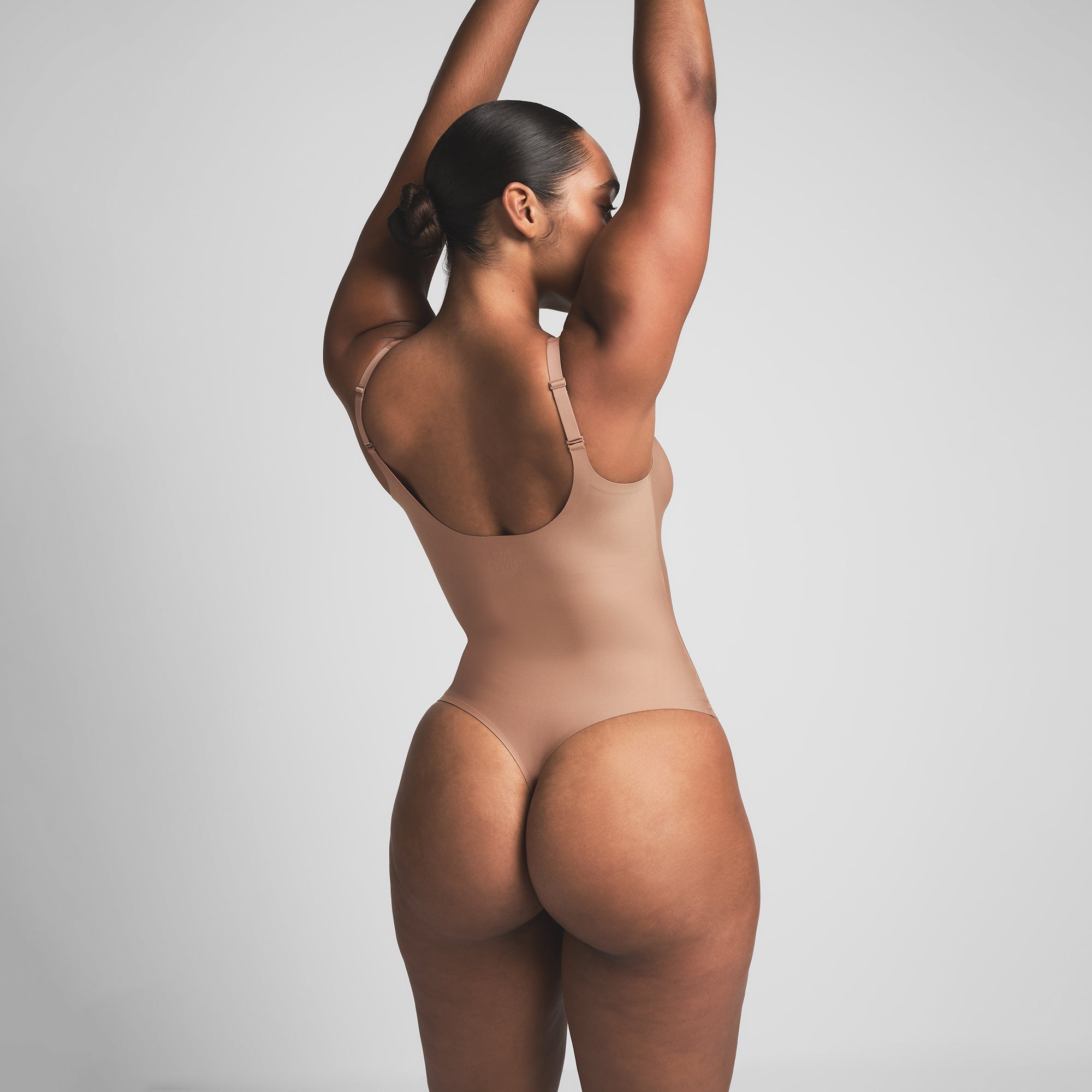 SKIMS BODY UNLINED PLUNGE THONG BODYSUIT | SIENNA ON A MODEL BACK VIEW