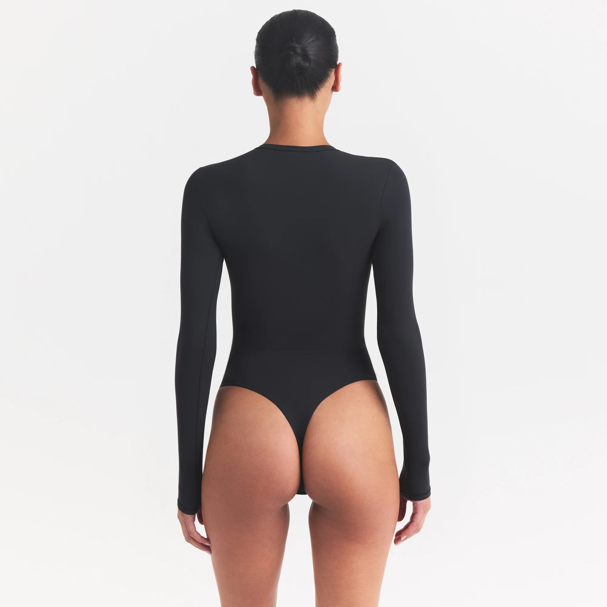 FITS EVERYBODY LONG SLEEVE CREW NECK BODYSUIT | ONYX ON A MODEL SIDE VIEW @ | FOCUS: 0.0, 1.0, 0.9
