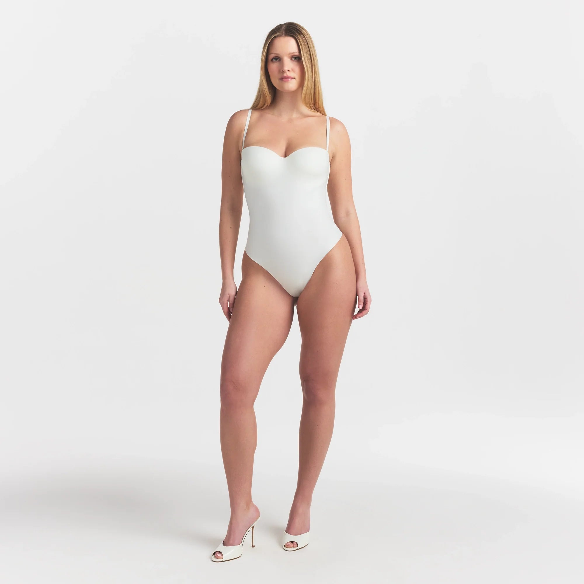 SKIMS BODY UNDERWIRE THONG BODYSUIT | IVORY ON A MODEL FRONT VIEW @
