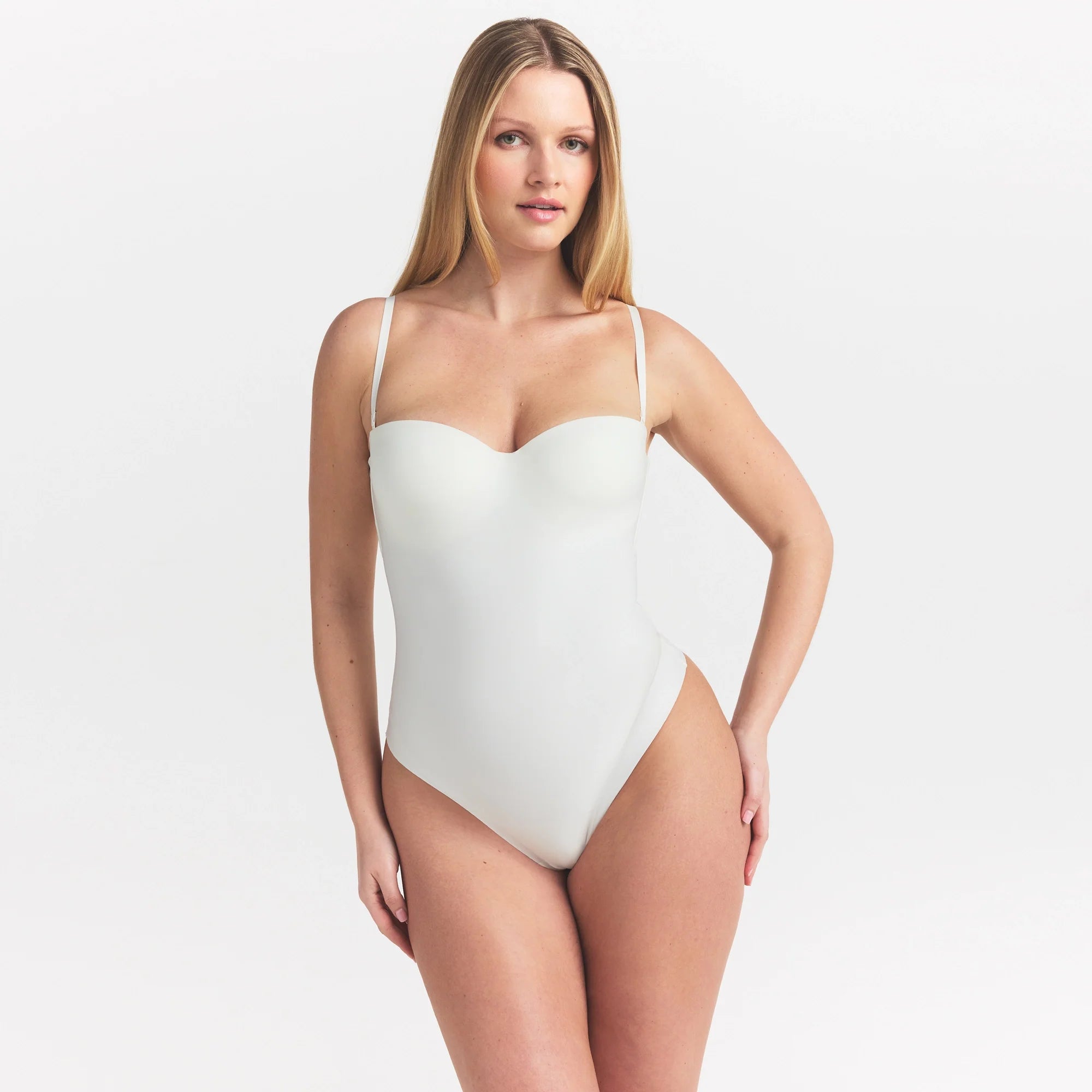 SKIMS BODY UNDERWIRE THONG BODYSUIT | IVORY ON A MODEL SIDE VIEW @