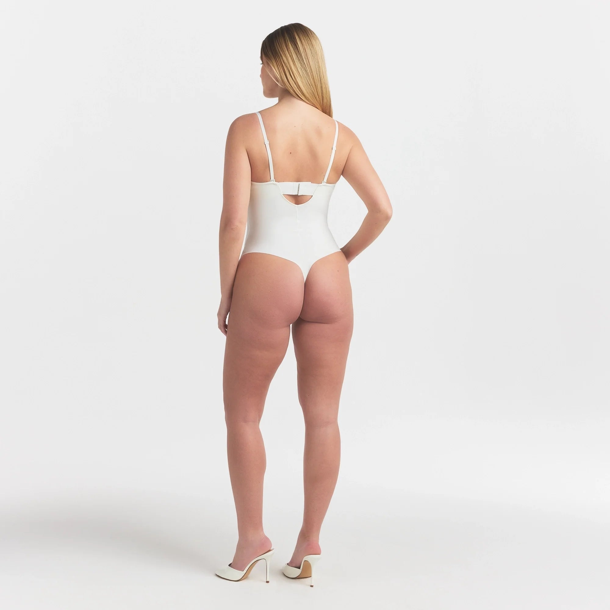 SKIMS BODY UNDERWIRE THONG BODYSUIT | IVORY ON A MODEL FRONT VIEW @